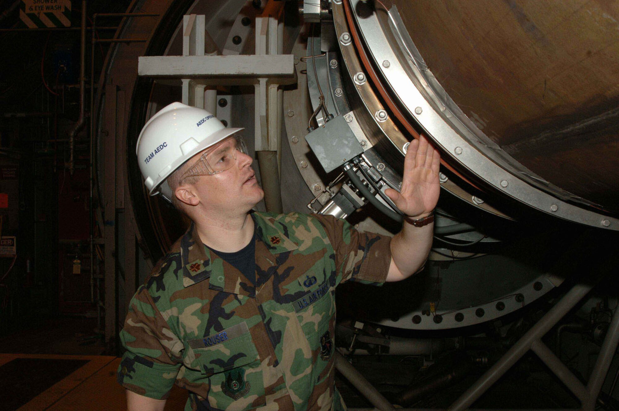 Maj. Kurt Rouser, Arnold Engineering Development Center’s Operations Officer, points out the flexible inlet duct in the center’s J-2 Engine Test Cell. (Photo by David Housch)
