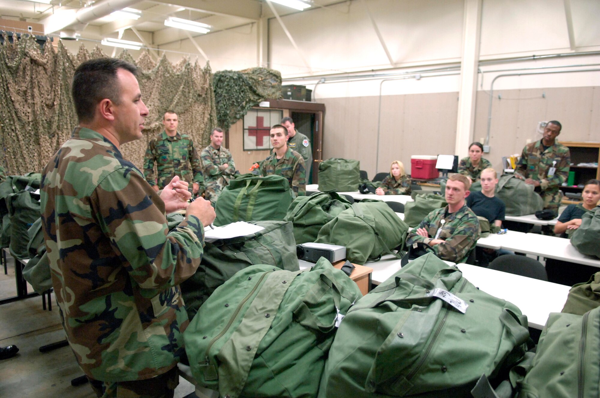 MOUNTAIN HOME AIR FORCE BASE, Idaho -- Capt. Andrew Mattern, 366th Aeromedical Dental Squadron, briefs his troops June 21 on the importance of having the correct gear when deploying. The 366th ADS participated in a "bag drag" to ensure troops had all necessary equipment in their deployment bags as the base's Sharpshooter exercise continued this week. (U.S. Air Force photo/Airman 1st Class Ryan Crane)