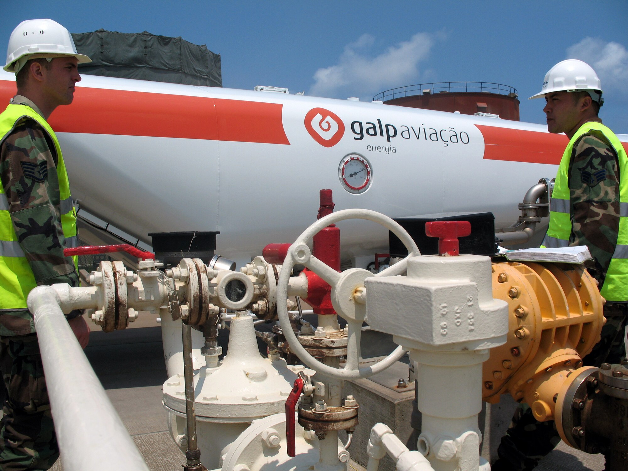 Staff Sgt. Drew Kilian and Senior Airman Aristotle Munoz pump fuel into a civilian fuel truck June 21 at Lajes Field, Portugal. Ongoing construction at Lajes Field includes an update and expansion to the fuel hydrant system. The project will double the capabilities of the current system. The Airmen are fuels hydrant operators assigned to the 65th Logistics Readiness Squadron. (U.S. Air Force photo/Senior Airman Troy Davis)