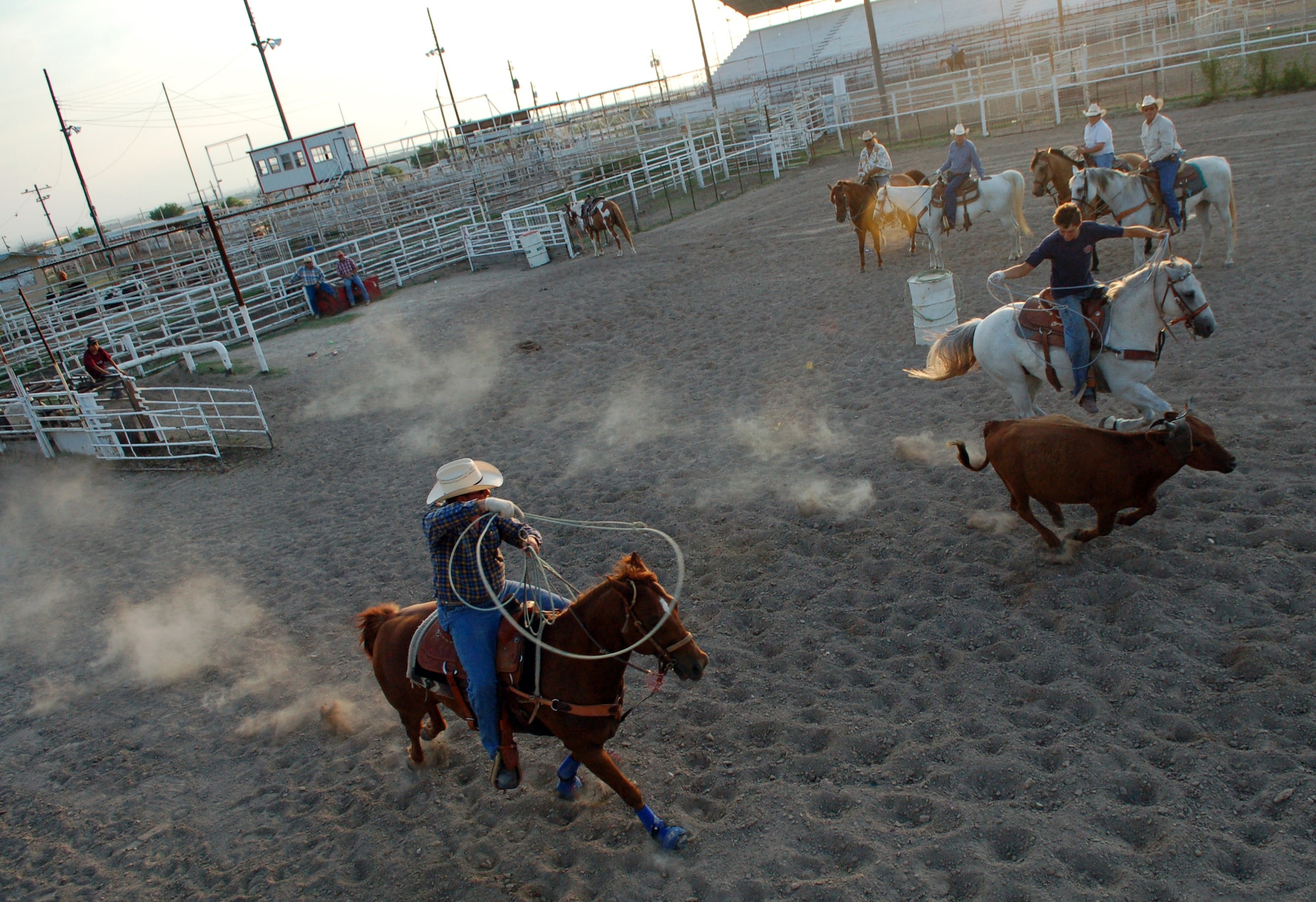 DEL RIO, Texas – As Jeff Scott, riding “Seven,” prepares to rope a speeding steer during team roping practice at Val Verde County Fairgrounds, Colton Sellers attempts to get his lasso around the animal’s horns.  Local members of the Professional Armed Forces Rodeo Association’s Burning Sands circuit practice Tuesdays and Thursdays.  (U.S. Air Force photo by Staff Sgt. Austin M. May)