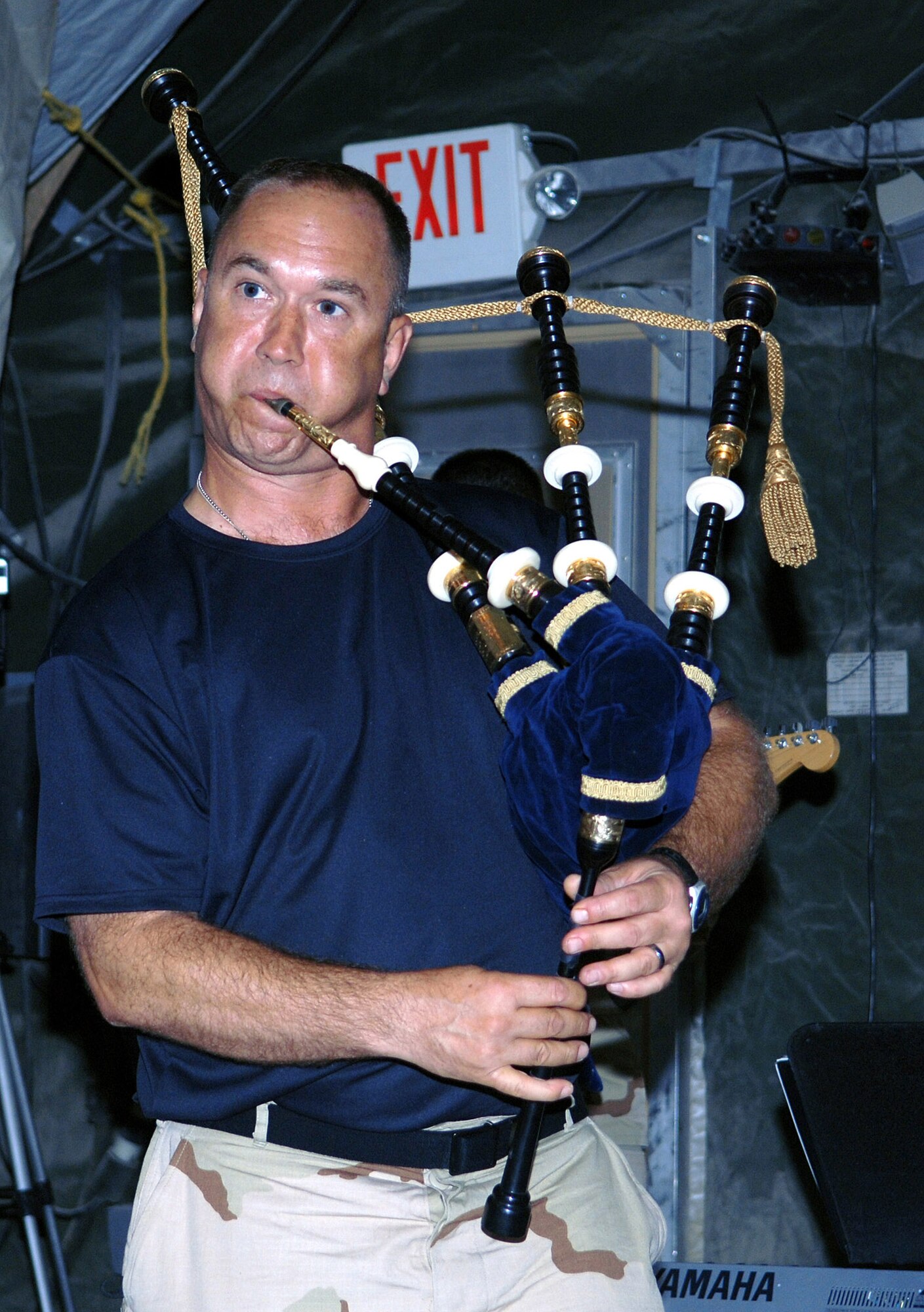 Master Sgt. Scott Gunn, CENTAF band tenor sax, bagpipe and guitar player, squeezes out a high energy performance of the song "Desert Storm" on his bagpipes during an impromptu performance at Bagram Airfield, Afghanistan June 19. The band's high spirited performance inspired Airmen of the 455th Air Expeditionary Wing in the audience to get up and dance. (photo by Staff Sgt. Craig Seals)