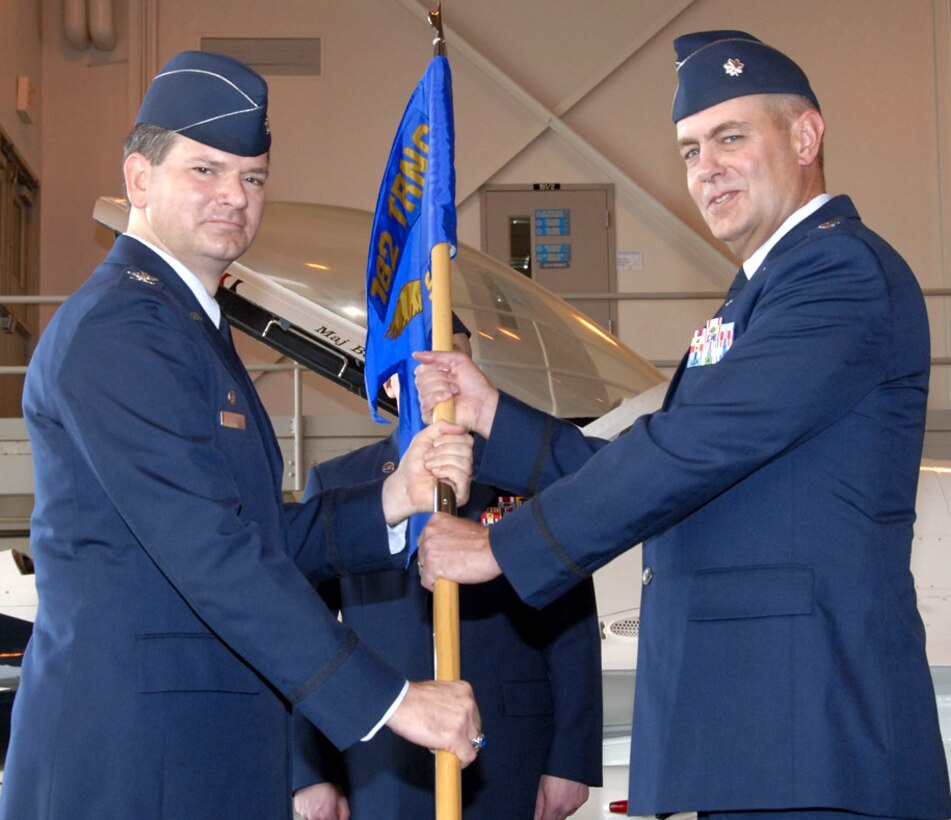 782nd Training Group Commander Col. Andrew Cain passes command of the 366th Training Squadron to Lt. Col. Matthew Bobb in a ceremony at Hangar 1010 on June 21. Colonel Bobb replaces Lt. Col. David Caffee. (U.S. Air Force photo/Sandy Wassenmiller)