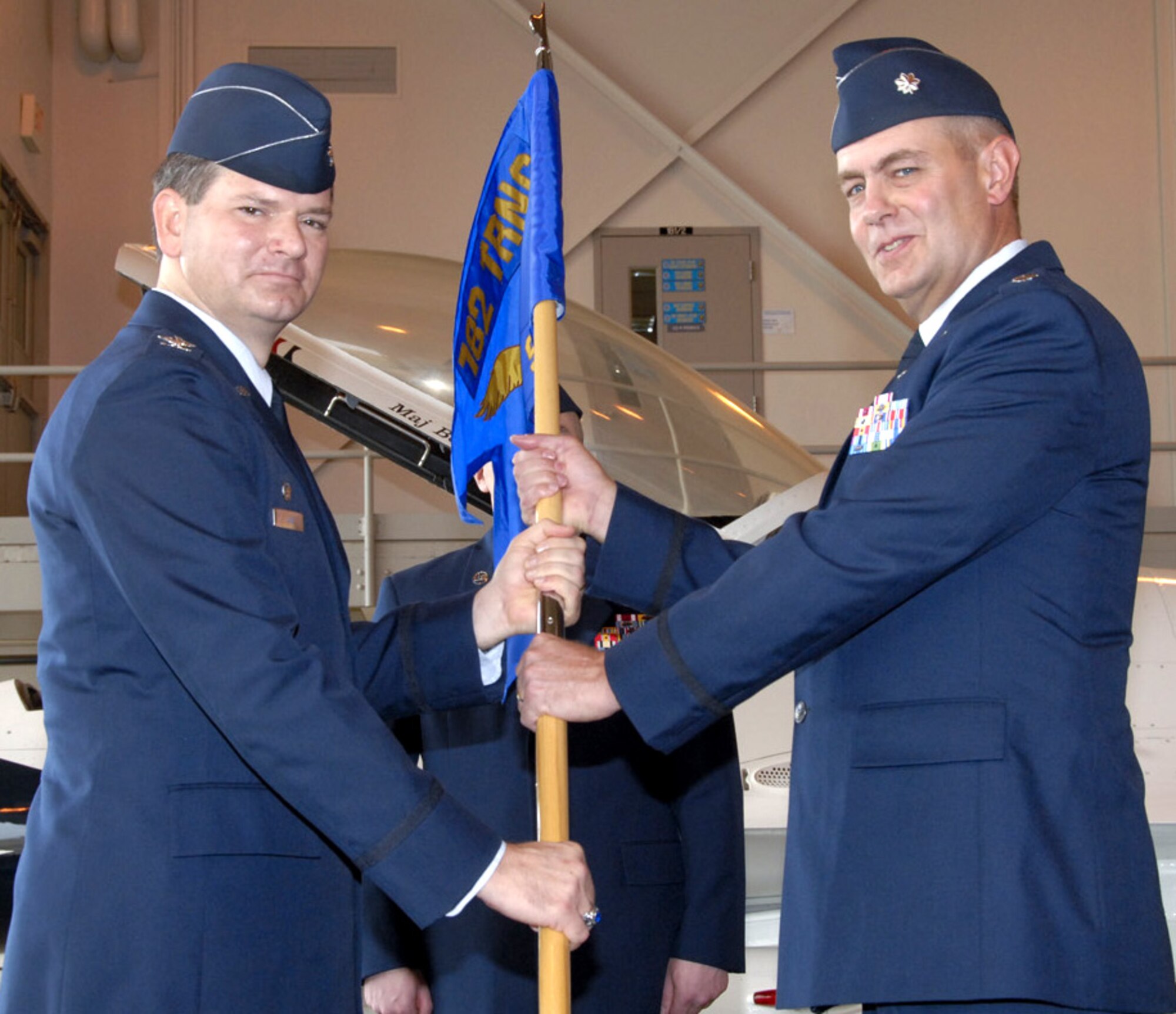 782nd Training Group Commander Col. Andrew Cain passes command of the 366th Training Squadron to Lt. Col. Matthew Bobb in a ceremony at Hangar 1010 on June 21. Colonel Bobb replaces Lt. Col. David Caffee. (U.S. Air Force photo/Sandy Wassenmiller)