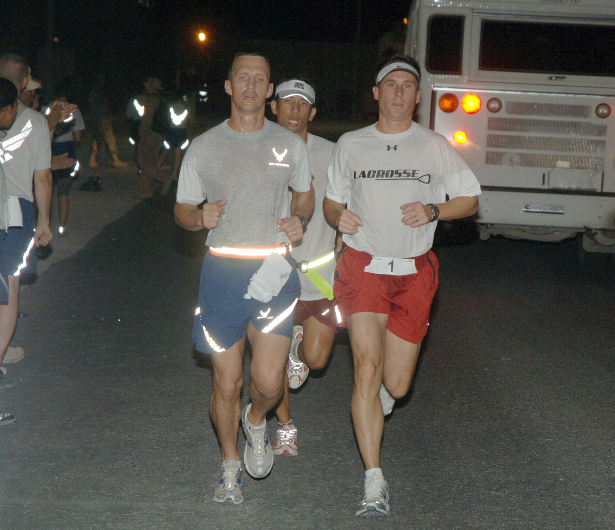 Members of the Desert Eagle Team log another lap during a half marathon held here June 18. The race was organized by the British Royal Air Force to benefit the British Limbless Ex Service Members Association. (U.S. Air Force photo by Master Sgt. Ken Stephens)