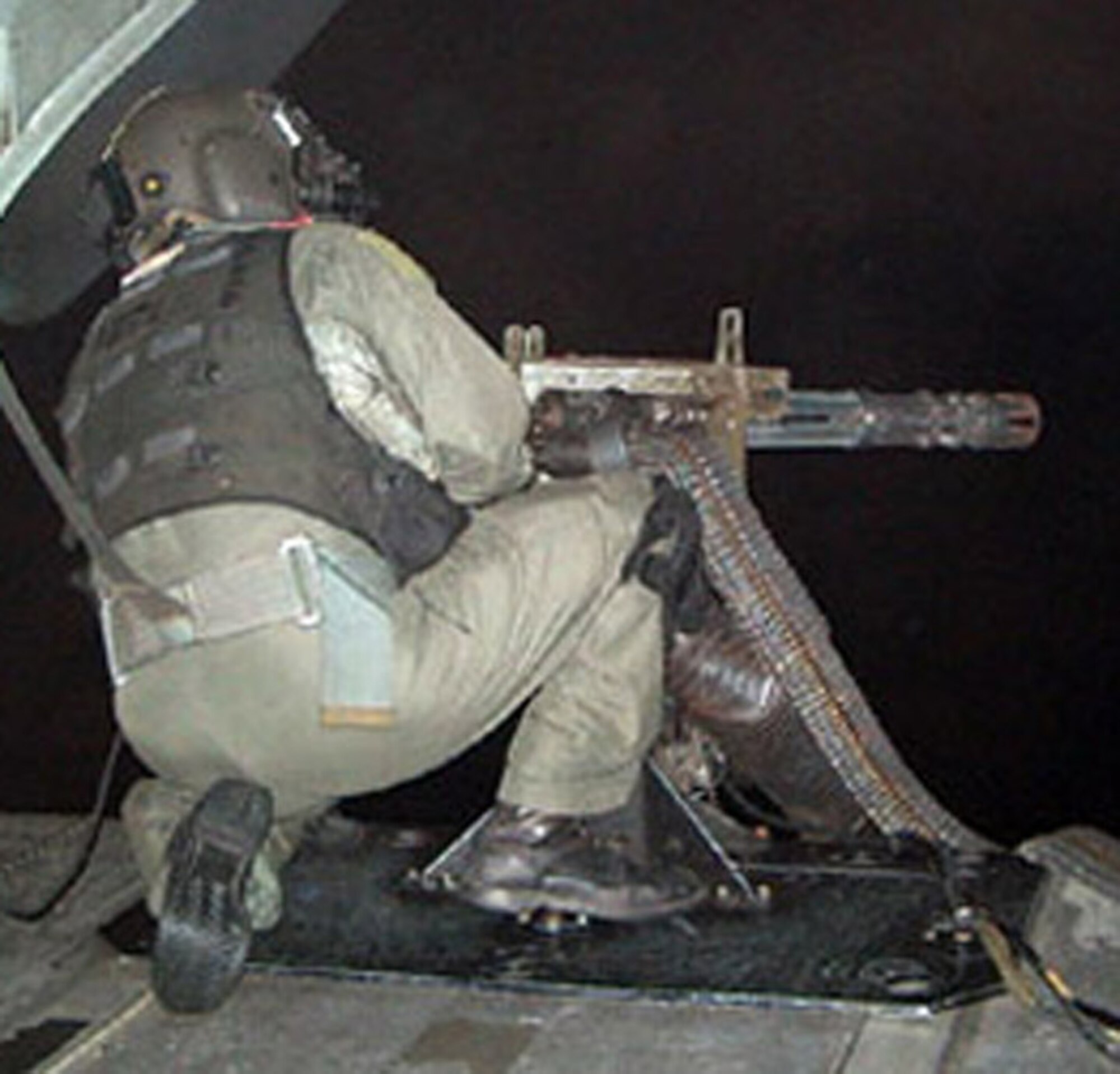 Master Sgt. Byron Allen, 1st Special Operations Group, works his 7.62 mini-gun from the back of an MH-53 PAVE LOW helicopter. Also one of the first six Airmen to receive the Air Force Combat Action Medal, Sergeant Allen was selected for the prestigious honor because of his heroics on a mission in Iraq in 2004. (Courtesy photo)