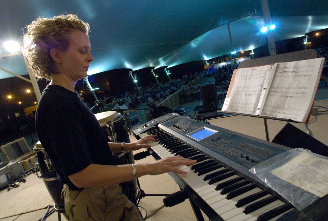 Staff Sgt. Amy Layhew of the U.S. Central Air Forces Expeditionary Band "Thunder Roll" performs at a concert in Southwest Asia June 16. "Thunder Roll," is bringing a touch of home to servicemembers fighting the war on terrorism.  Sergeant Layhew is with the Illinois Air National Guard. (U.S. Air Force photo/Master Sgt. Jim Varhegyi)
