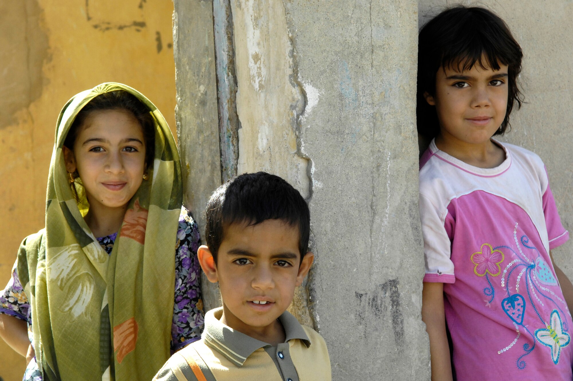 Iraqi children in a small village near the city of Lutafiyah, Iraq, watch as coalition forces conduct a search. Children come out of their homes during these times to satisfy their curiosity.  Lutafiyah located in the southern sector of Baghdad. (U.S. Air Force photo/Master Sgt. Jonathan Doti)