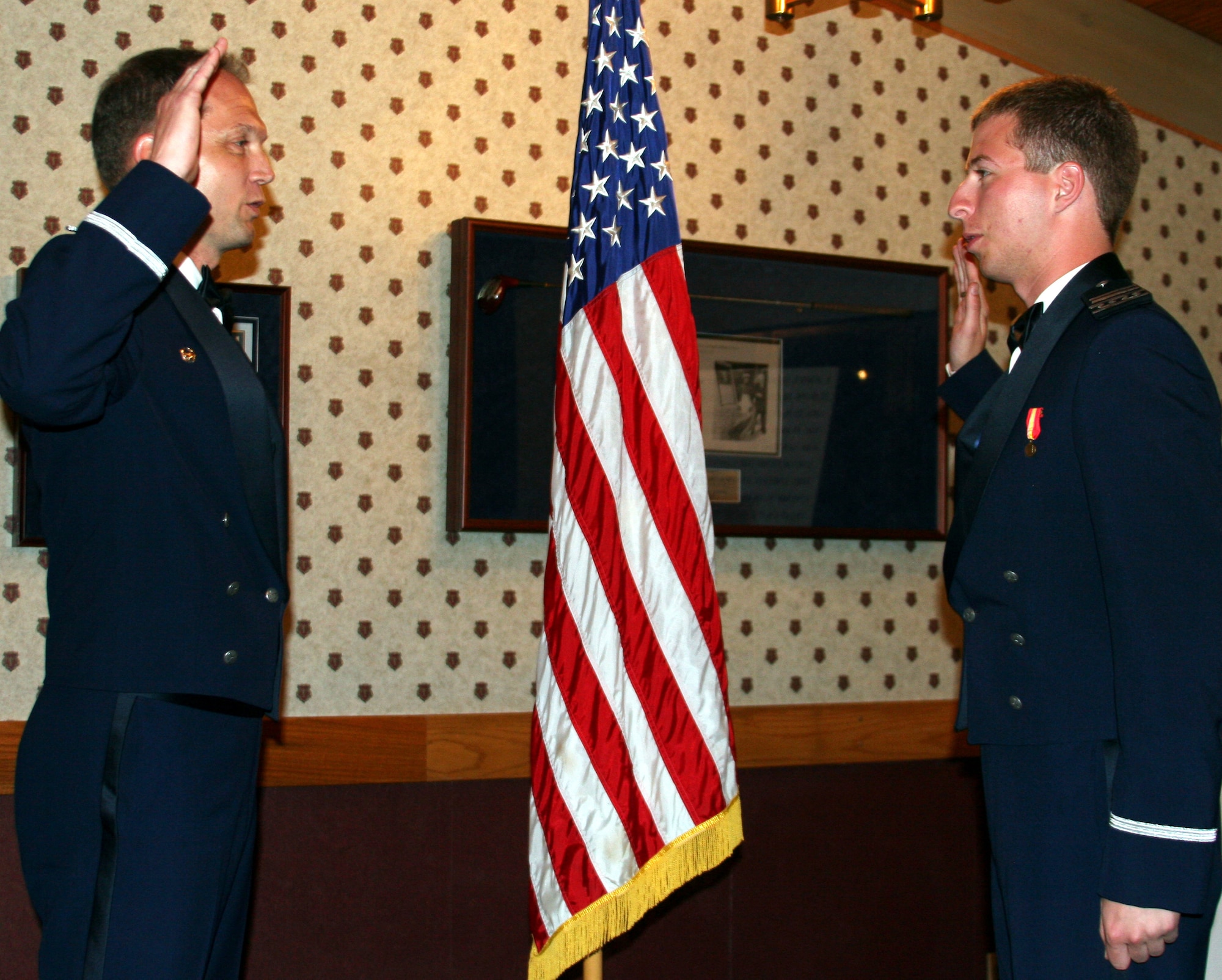 Left, Col. Hal Rice, 305th Operations Group commander, administers the Oath of Office to his son, 2nd Lt. Brandon Rice, at his U.S. Air Force Academy graduation. (Courtesy GerMaine Photography)
