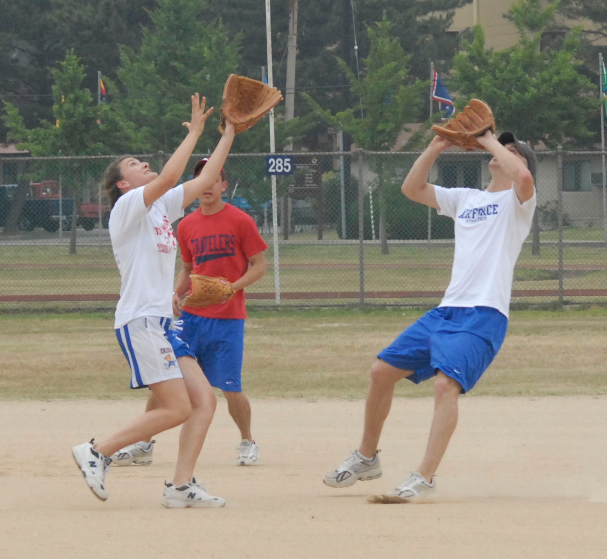 KUNSAN AIR BASE, Republic of Korea -- Cadets Betsey Blair (L), Jack Jessup (C), and Reid Geiser (R), all go for the ball during a softball game here June 21.  (U.S. Air Force photo/Staff Sgt. Darcie Ibidapo)
