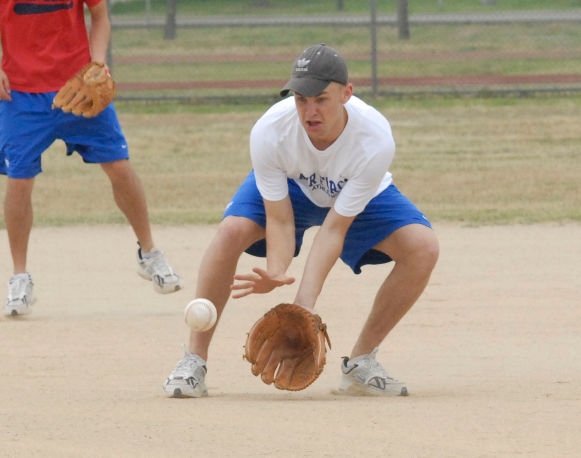 KUNSAN AIR BASE, Republic of Korea -- Reid Geiser, a Cadet from the U.S. Air Force Academy, catches a ground ball during a softball game here June 21. (US Air Force photo/Staff Sgt. Darcie Ibidapo)