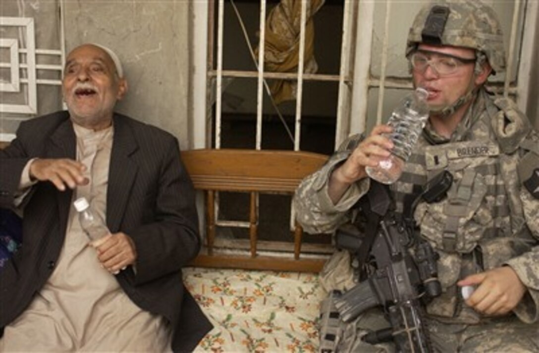 U.S. Army 1st Lt. Lance Brender shares a laugh and a drink of water with an Iraqi citizen in Rashid, Iraq, on June 20, 2007.  Brender is the platoon leader of 4th Platoon, Charlie Company, 2nd Battalion, 3rd Infantry Regiment, 3rd Stryker Brigade Combat Team, 2nd Infantry Division out of Fort Lewis, Wash.  