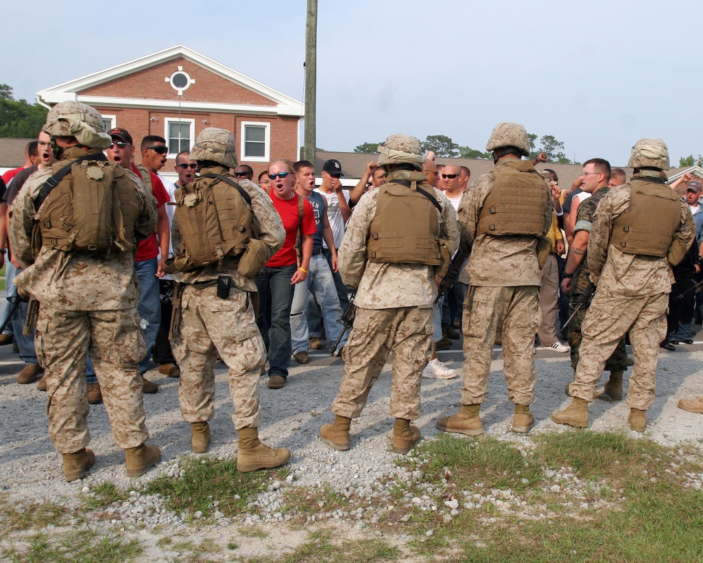 Marines with the 22nd Marine Expeditionary Unit contain a group of angry role players who were protesting the presence of American military personnel during a portion of the unit's Certification Exercise June 22, 2007. The Marines and Sailors of the 22nd MEU were conducting a simulated non-combatant evacuation of American personnel from the beleaguered, notional country of Amberland. The role-players added needed realism to the training as the Marines prepare for deployment. (Official Marine Corps Photo by Sgt. Ezekiel R Kitandwe)::n::