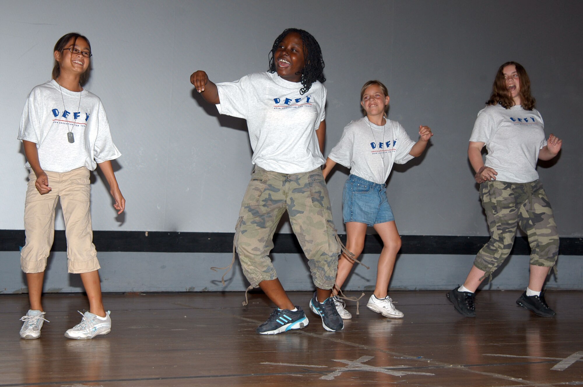 Lana Robinson, front,  leads her group in a dance during the week long Drug Education for Youth training session. The program covered drug identification and dealing with peer preasure, as well as a cardboard boat regata, held at the base beach June 13. 

                 