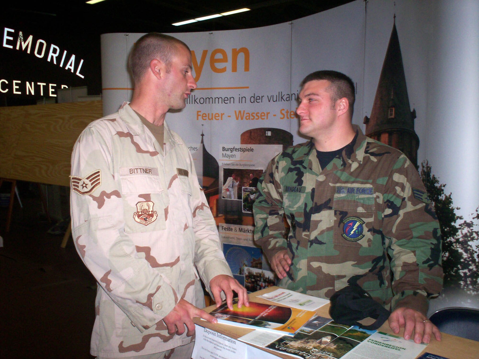 SPANGDAHLEM AIR BASE, GERMANY -- Staff Sgt. David Bittner and Senior Airman Shaun Riendeau, both from the 52nd Logistics Readiness Squadron, talk about what they would like to do during Explore the Eifel at an information fair June 22, 2007. The 52nd Fighter Wing's "Explore the Eifel" program aims to provide military members and their families the opportunity to spend a few days experiencing local culture firsthand while expanding relationships with friends in nearby German communities. (US Air Force photo/Staff Sgt. Tammie Moore)