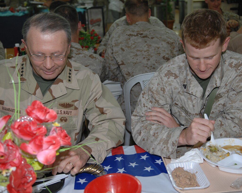 U.S. Navy Admiral Edmund P. Giambastiani, vice chairman of the Joint Chiefs of Staff, talks with U.S. Marine Cpl. Brian Jones, geospatial intelligence specialist, over lunch at the dining facility in Fallujah, Iraq, June 21, 2007. Giambastiani visited troops in Iraq to find out about operations, thank troops for their service and to find out if they had all the tools they needed to do their job.