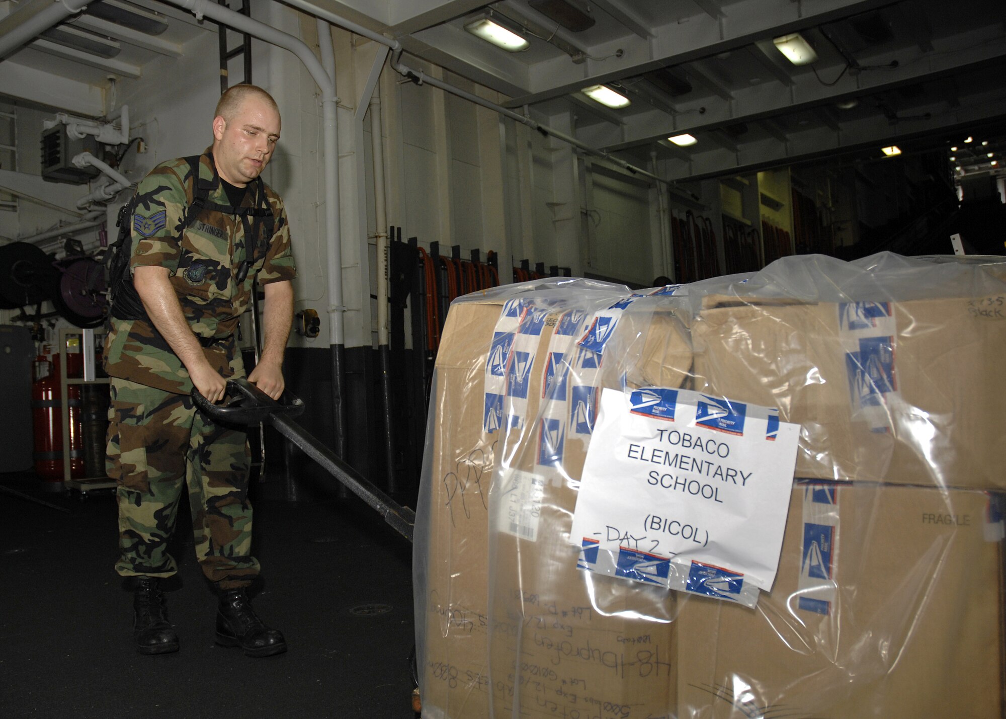 COTABATU, Philippines (June 21, 2007) - Air Force Staff Sgt. Christopher Stringer, attached to the 3rd Medical Support Squadron, moves a pallet of supplies aboard USS Peleliu (LHA 5) bound for a community relations project as part of Pacific Partnership 2007. U.S. Navy photo by Mass Communication Specialist 3rd Class Bryan M. Ilyankoff 