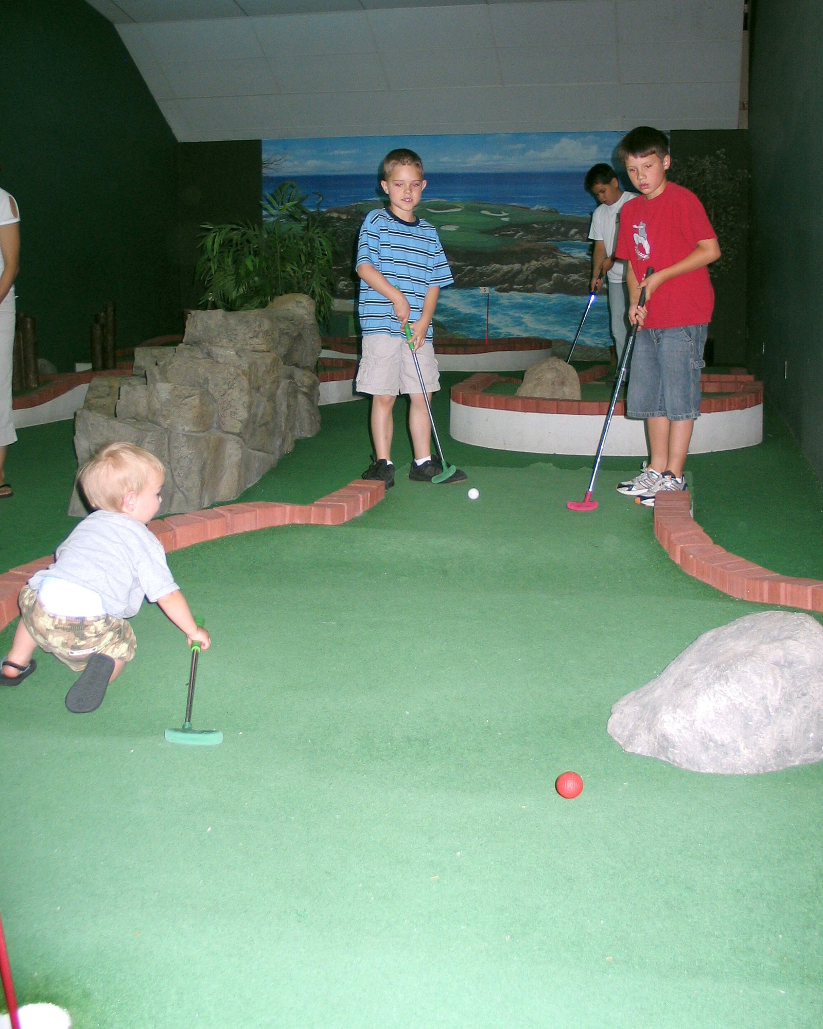 FAIRCHILD AIR FORCE BASE, Wash. – Ian McNerney (left), 7, son of Lt. Col. Michael McNerney, 66th Training Squadron director of operations; and Erik Holm, 8, son of Lt. Col. John Holm, 66th Training Squadron commander, play put-put golf at the Funspot June 21 during Family Fun Day. More than 460 people flocked to the Funspot to bowl, golf, roller skate and face paint during the annual event. (U.S. Air Force photo/Staff Sgt. Connie L. Bias)
