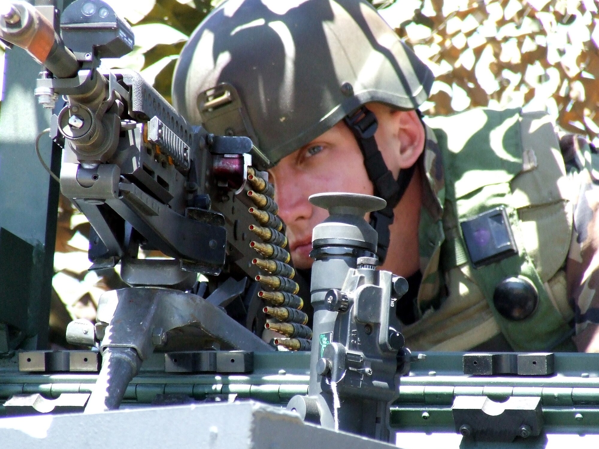 Airman 1st Class William Carson takes aim with a blank-round-equipped M-60 machine gun at a security checkpoint for the contingency response group at Naval Air Engineering Station Lakehurst, N.J., June 23.  Airman Carson is assigned to the 818th Global Mobility Readiness Squadron at McGuire Air Force Base, N.J. He participated in Exercise Eagle Flag 07-5, operated by the U.S. Air Force Expeditionary Center at Fort Dix, N.J.  (U.S. Air Force photo/Tech. Sgt. Scott T. Sturkol)