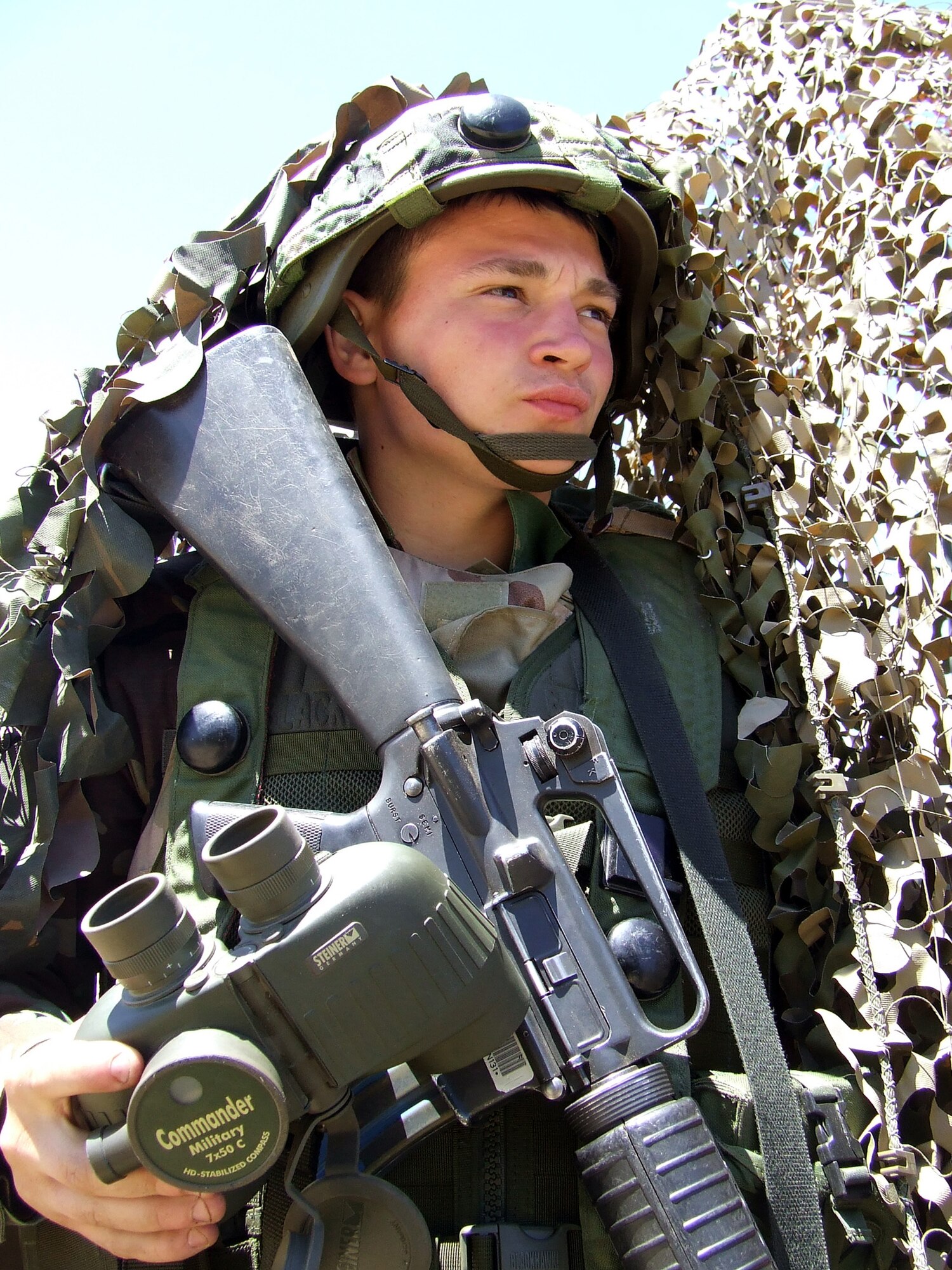 Airman Thomas Stevens keeps a look out for "opposing forces" at a security checkpoint for his contingency response group camp at Exercise Eagle Flag 07-5 June 23.  Airman Stevens is an air transportation apprentice from the 819th Global Support Squadron at McGuire Air Force Base, N.J. The exercise is operated by the U.S. Air Force Expeditionary Center's 421st Combat Training Squadron at Fort Dix, N.J.  (U.S. Air Force photo/Tech. Sgt. Scott T. Sturkol)