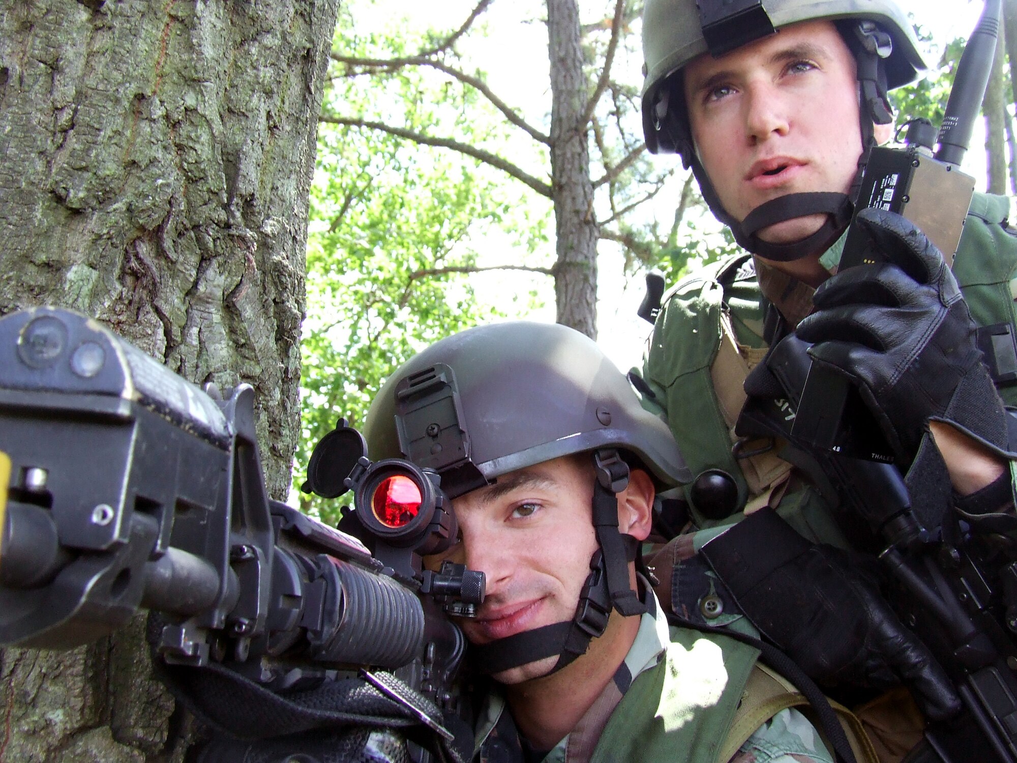 Airman 1st Class Travis Fillman and Senior Airman Kelly Gallmann watch over a security checkpoint for the contingency response group at Naval Air Engineering Station Lakehurst, N.J., June 23.  Both Airmen are with the 817th Contingency Response Group at McGuire Air Force Base, N.J. They participated in Exercise Eagle Flag 07-5, operated by the U.S. Air Force Expeditionary Center at Fort Dix, N.J.  (U.S. Air Force photo/Tech. Sgt. Scott T. Sturkol)