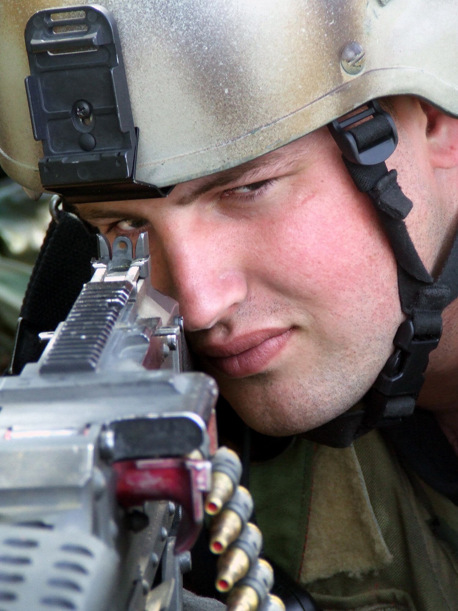 Airman 1st Class Tyler Wildman  takes aim with a blank-round-equipped M-60 machine gun at a security checkpoint for the contingency response group at Naval Air Engineering Station Lakehurst, N.J., June 22.  Airman Wildman participated in Air Force Exercise Eagle Flag 07-5, operated by the U.S. Air Force Expeditionary Center at Fort Dix, N.J.  (U.S. Air Force photo/Tech. Sgt. Scott T. Sturkol)