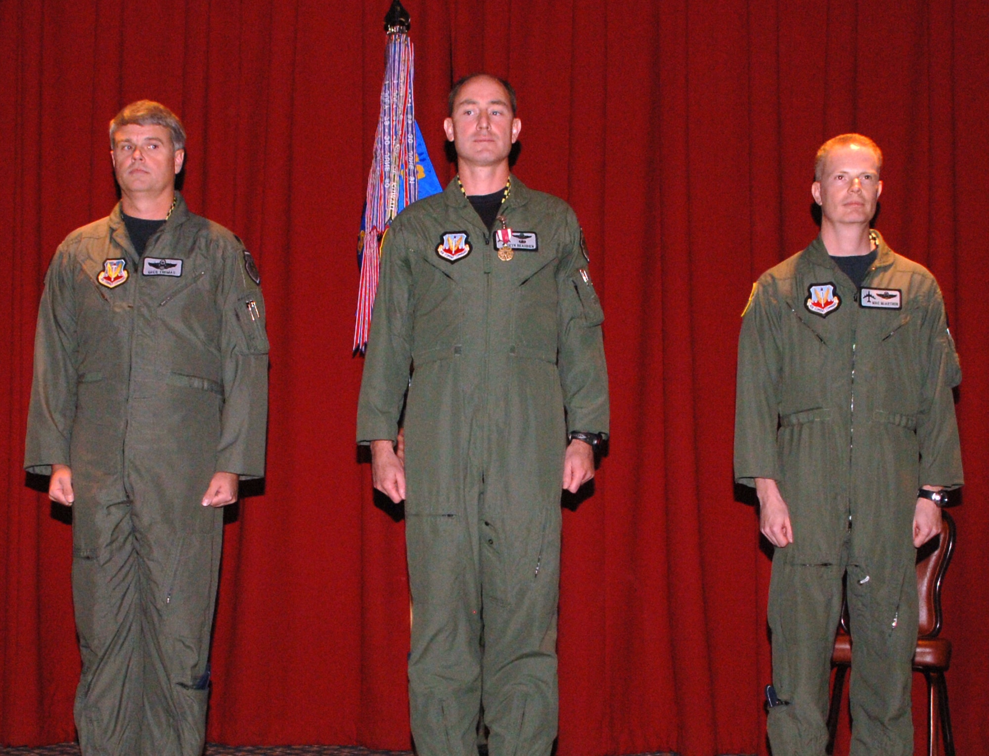 FAIRCHILD AIR FORCE BASE, Wash. – From left, Lt. Col. Gregory Thomas, USAF Weapons School Commandant; Lt. Col. Seth Beaubien, former 509th Weapons Squadron commander; and Lt. Col. Howard McArthur, 509th commander, prepare to pass the guide-on during the 509th WPS change of command ceremony here June 22. (U.S. Air Force photo/Airman 1st Class Joshua Chapman)