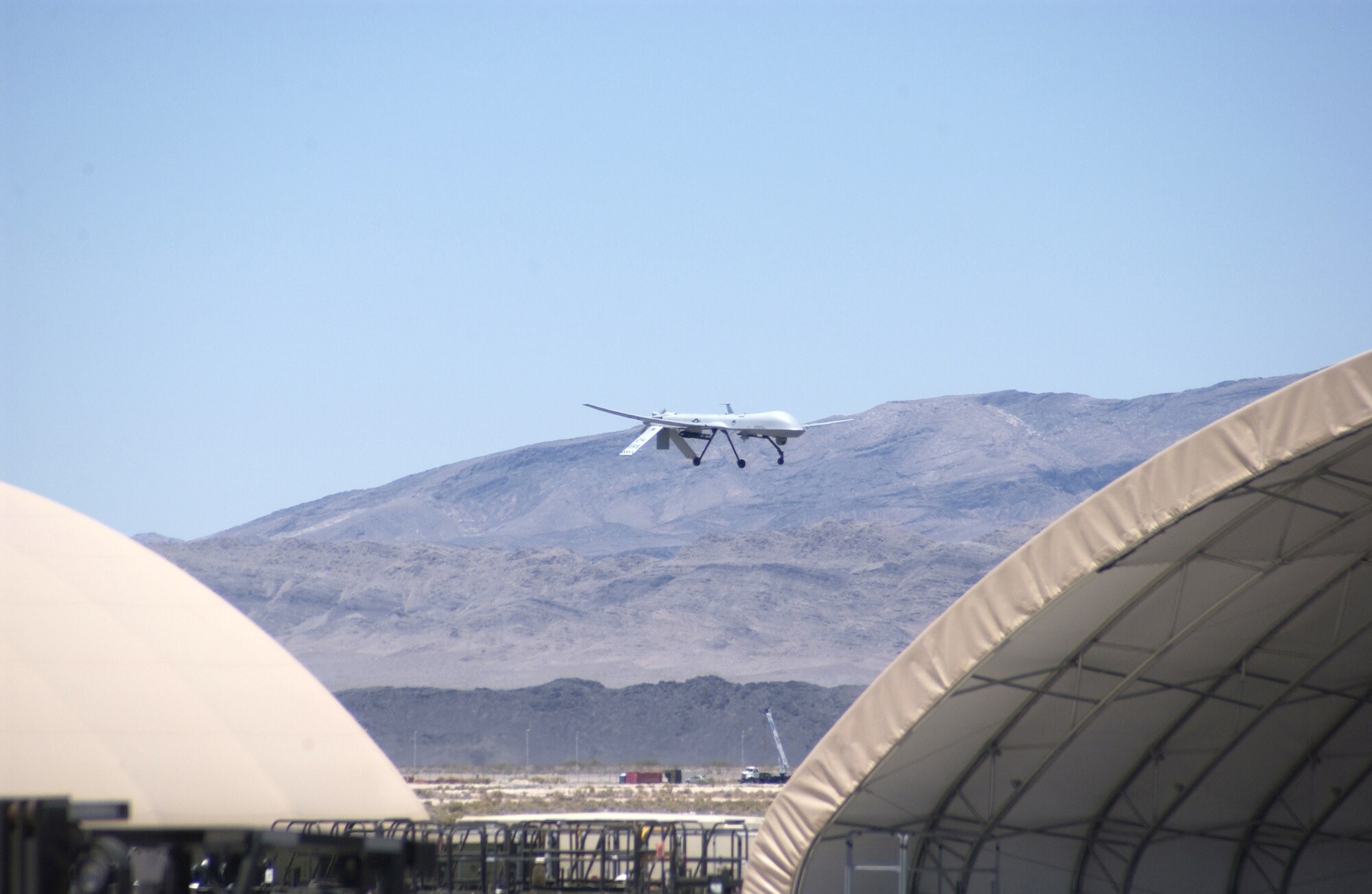 An MQ-1 Predator conducts a low pass commemorating the 250,000th flight hour of the airframe June 22, 2007, Creech Air Force Base, Nev. The Predator is assigned to the 11th Reconnaissance Squadron at Creech. (U.S Air Force Photo by Senior Airman Larry E. Reid Jr.)