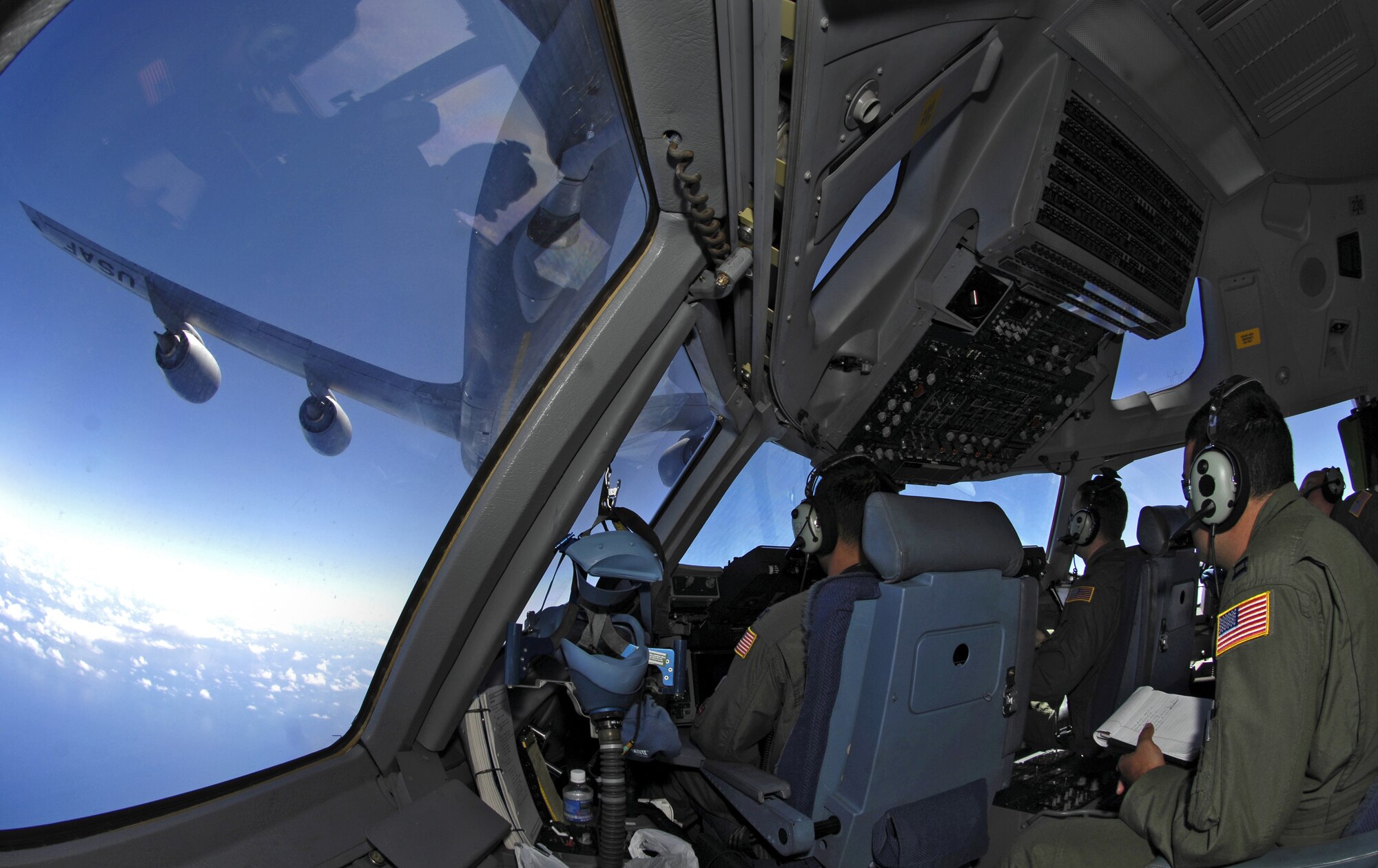 C-17 Globemaster III aircrew members practice aerial refueling as their aircraft receives fuel from a KC-135 Stratotanker June 22, 2007 during a refueling training mission. The C-17 from the 535th Airlift Squadron, Hickam Air Force Base, Hawaii and the KC-135 from the 909th Air Refueling Squadron, Kadena Air Base, Japan are practicing for the upcoming Air Mobility Command Rodeo. (U.S. Air Force photo/ Tech. Sgt. Shane A. Cuomo)