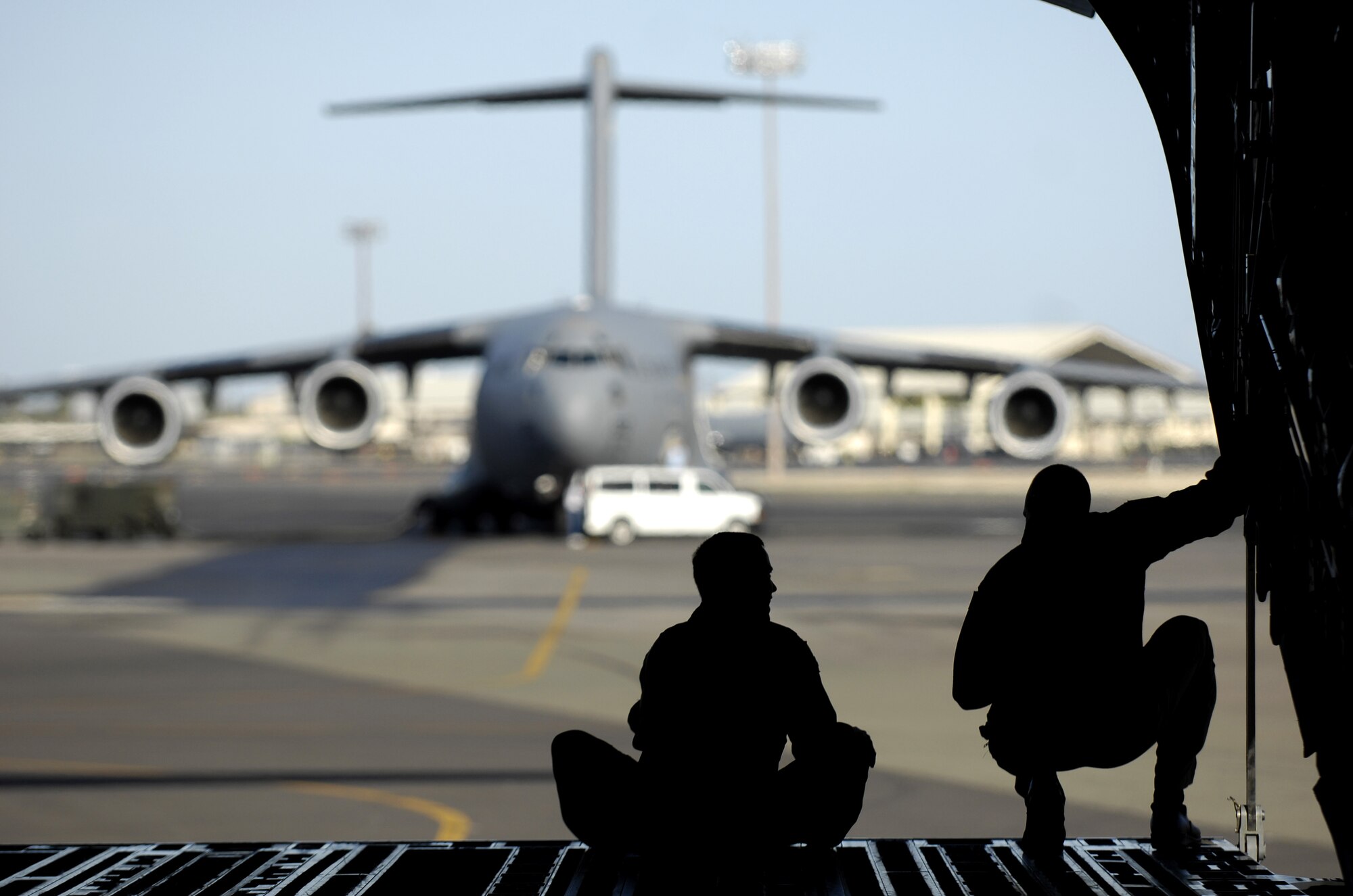 Maj. Jason Mills and Tech. Sgt. Ansen Lucas discuss techniques for backing their C-17 Globemaster III prior to departing June 22, 2007 on a refueling training mission from Hickam Air Force Base, Hawaii. A KC-135 Stratotanker from the 909th Air Refueling Squadron, Kadena Air Base Japan is at Hickam practicing with the Globemaster crew from the 535th Airlift Squadron for the Air Mobility Rodeo.  Sergeant Lucas is a loadmaster and Major Mills is a pilot with the 535th AS. (U.S. Air Force Photo/ Tech. Sgt. Shane A. Cuomo) 
