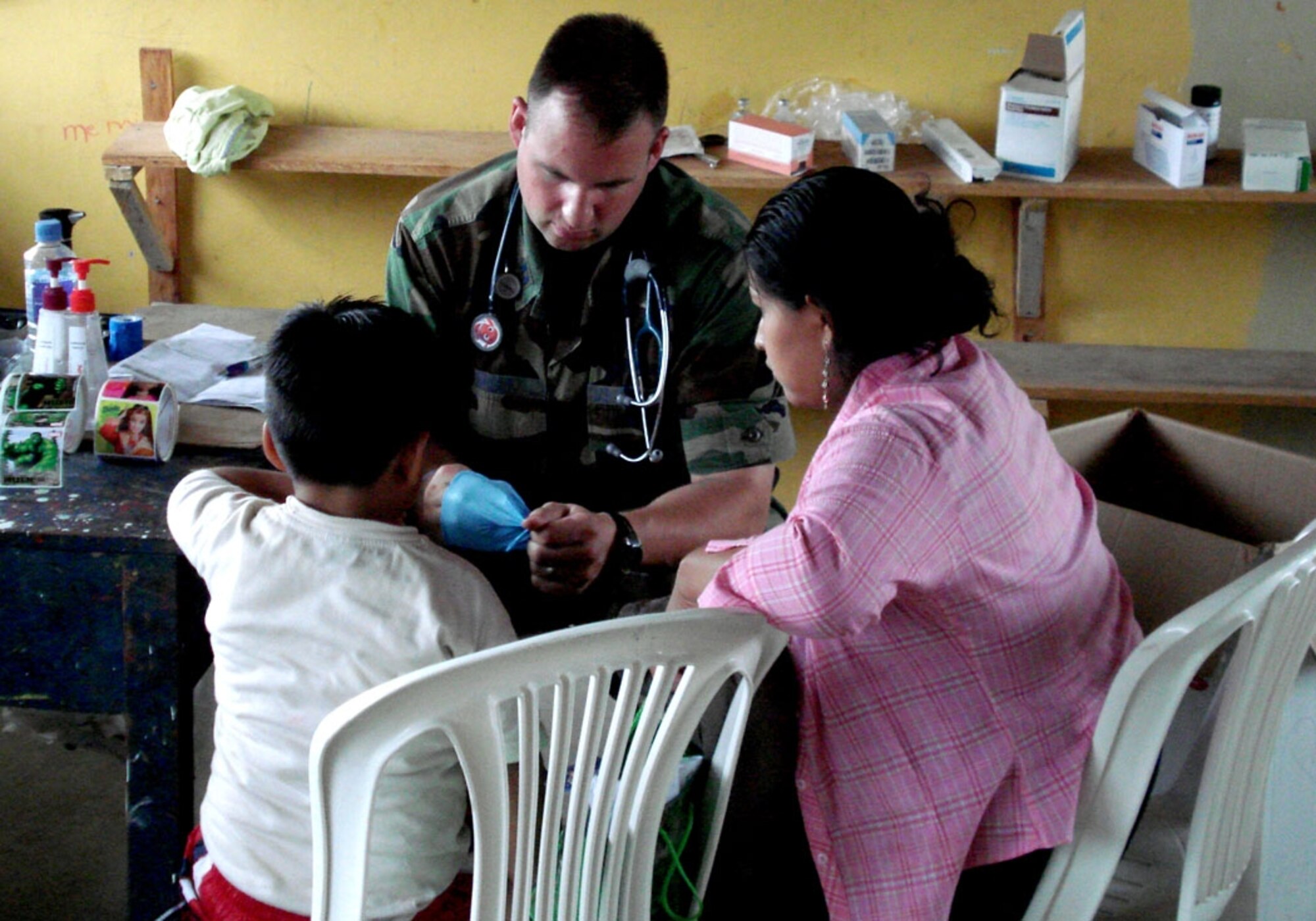 A 49th Medical Group physician finishes up with a patient during the Medical Readiness Training Exercise in Ecuador. Fourteen Airman traveled there for two week on this humanitarian assistance deployment and treated more than 6,800 patients and filled more than 17,500 prescriptions. (U.S. Air Force photo/courtesy of the 49th Medical Group MEDRETE team)