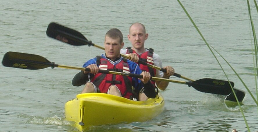 Staff Sgt. Terrell Rarig (front) and Staff Sgt. Jonathan Phillips canoe their way to the finish line during a recent Valdosta Racing Team event. Sergeant Phillips also participates on Moody's triathlon team as a way to stay in shape and exemplify a "fit to fight" lifestyle. (Courtesy photo)
