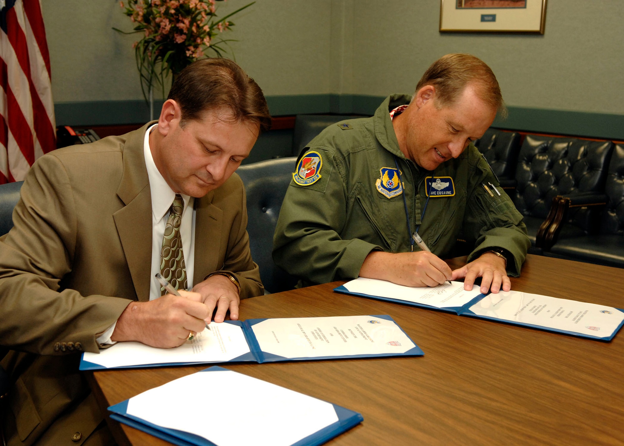 EGLIN AIR FORCE BASE, Fla.--American Federation of Government Employees Local 1897 President Peter Smith and Brig. Gen. David Eidsaune, Air Armament Center Commander and Program Executive Officer for Weapons signed a local supplement agreement to the Master Labor Agreement on June 25. (photo by Craig McDonnell)
