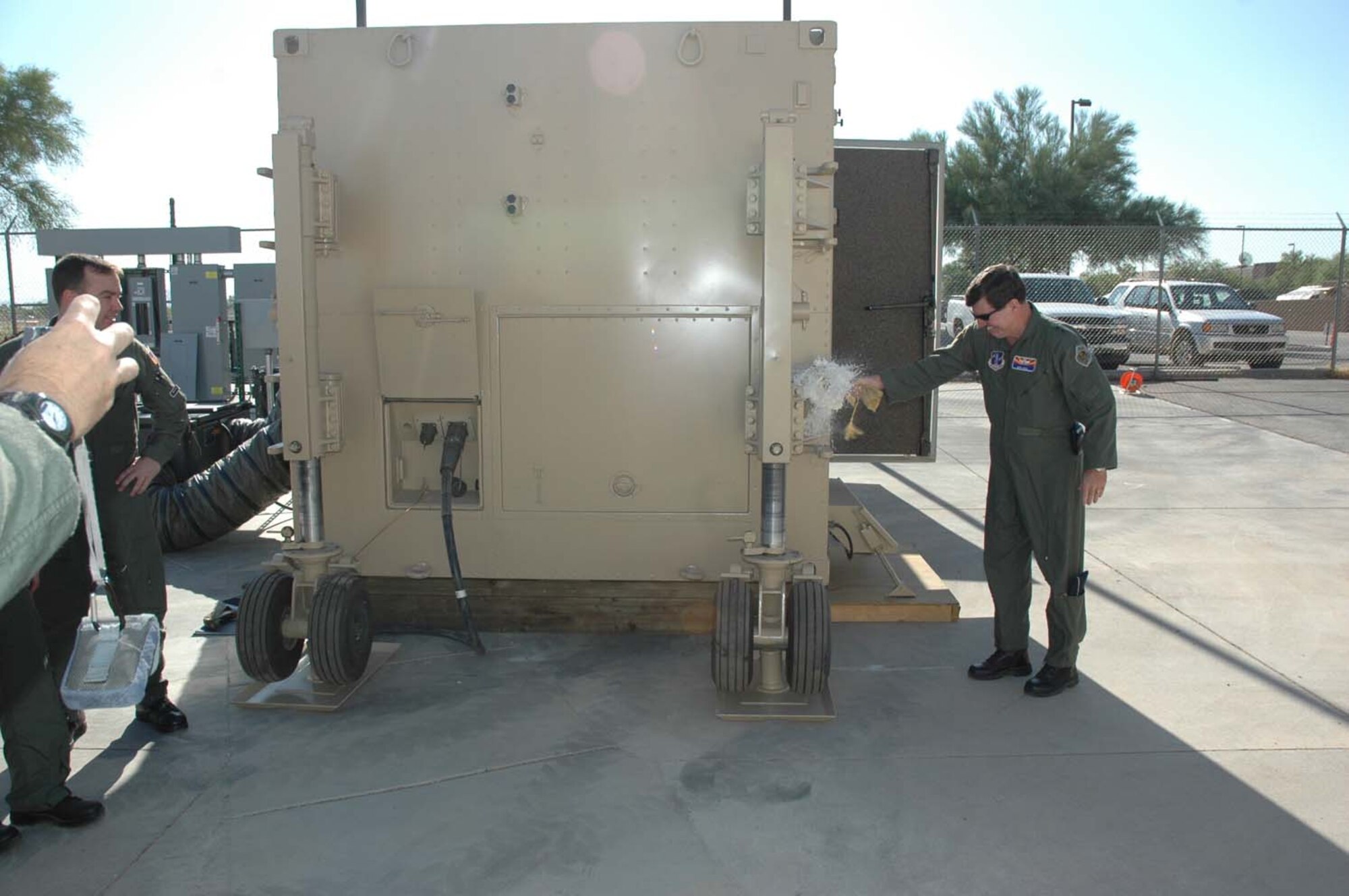 The Arizona Air National Guard's Predator Ground Control Station was christened, June 21 at 8 a.m. by Maj. Gen. Michael J. Shira, assistant adjutant general and commander, Joint Force Headquarters, Arizona Air National Guard, Phoenix, Arizona.  The GCS, which can be most closely compared to the cockpit of an aircraft will start operations in the next few weeks.  Arizona ANG aircrews trained to fly the Predator will fly combat missions 24 hours a day, seven days a week in support of our troops deployed in theater.  Although pilots and sensors controlling the aircraft will be right here at Davis-Monthan AFB, satellite technology allows the aircraft they are flying to physically be overseas supporting current combat operations.  The main mission of the Predator is to provide Intelligence, Surveillance and Reconnaissance (ISR), but often times falls into the role of Close Air Support (CAS).  In the CAS role, the Predator either works closely with other CAS assets, such as the A-10, or, in some cases provides firepower of it's own with the use of ROVER technology and Hellfire missiles.  The Arizona National Guard has been working tirelessly for nearly two years to make this mission a reality.  The combat theater's requests for the Predator are well above what can be provided at the current operations level and hopefully this is just the beginning of the Guard's role in helping to meet the needs of those in harm's way. The Arizona ANG would like to pass their thanks to the many units on Davis-Monthan who went above and beyond to provide the support needed to stand up this brand new combat mission squadron. (U.S. Air Force photo by Staff Sgt. Jake Richmond)