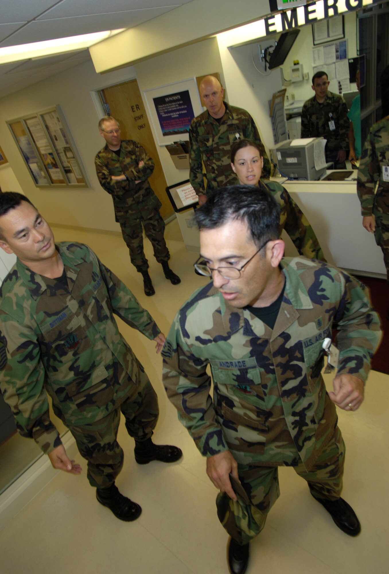 MOUNTAIN HOME AIR FORCE BASE, Idaho -- Tech. Sgt. Antonio Andrade, 366th Aeromedical Dental Squadron, frantically tries to find a way out of the hospital while members of the emergency clinic attempt to retain him during a mock situation for the Sharpshooter exercise here June 24. The 366th Security Forces Squadron conducted the scripted evaluation to test the responsiveness of Security Forces troops and the medical staff here. (U.S. Air Force photo/Airman 1st Class Ryan Crane)