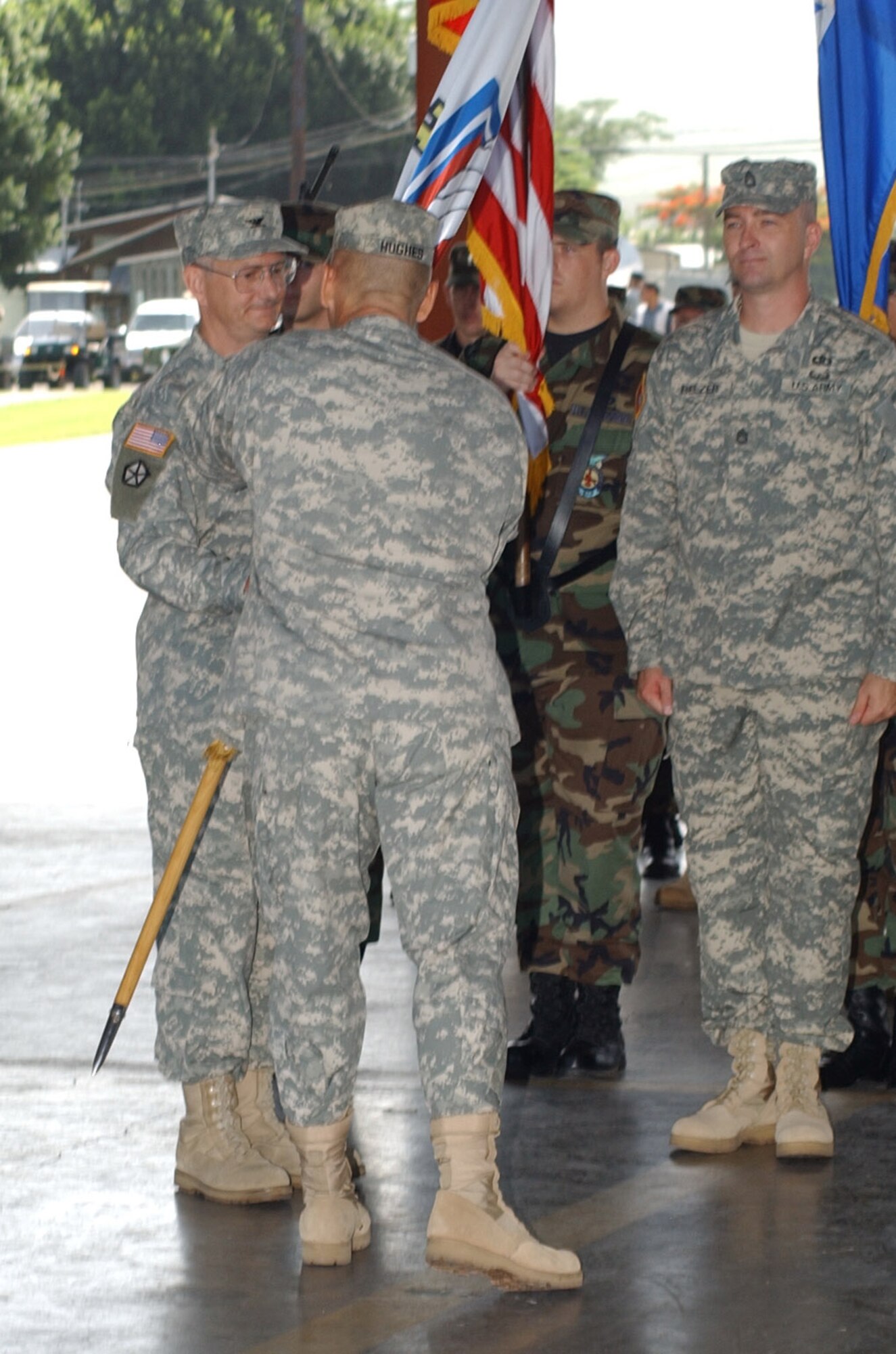 Army Col. Michael Sigmon, left, assumes command of the Joint Task Force-Bravo Medical Element by taking the MEDEL guidon from Col. Christopher Hughes, JTF-B commander, June 25 at the Soto Cano Air Base Fire Department. The MEDEL mission is to provide health service support and mobile surgical teams to U.S. Forces deployed in the U.S. Southern Command area of responsibility and more than 560 airmen and soldiers at Soto Cano Air Base; to conduct medical readiness training exercises (MEDRETES); and to serve as liaison to Honduran Ministries of Health. U.S. Air Force photo by Senior Airman Shaun Emery.