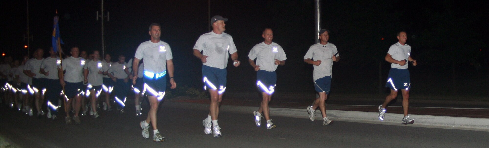 WHITEMAN AIR FORCE BASE, Mo. - Members of the 509th Security Forces Squadron, Brig. Gen. Greg Biscone, 509th Bomb Wing commander and Chief Master Sgt. Brian Hornback, 509th Bomb Wing command chief, run in formation to the Spirit Gate to move the squadron's B-2 magnet on the Spirit Challenge Honor Roll board to the 12-month mark at 3:45 a.m. June 24. Despite having 70 percent of its work force under 24, the 509th SFS was officially DUI free for a year. “This isn’t about us, the leaders, it’s about the Airmen taking care of each other and doing what is right,…being good wingmen” said Lt. Col. Craig Allton, 509th SFS commander. “They really make me proud.”  (U.S. Air Force photo/Airman 1st Class Stephen Linch)