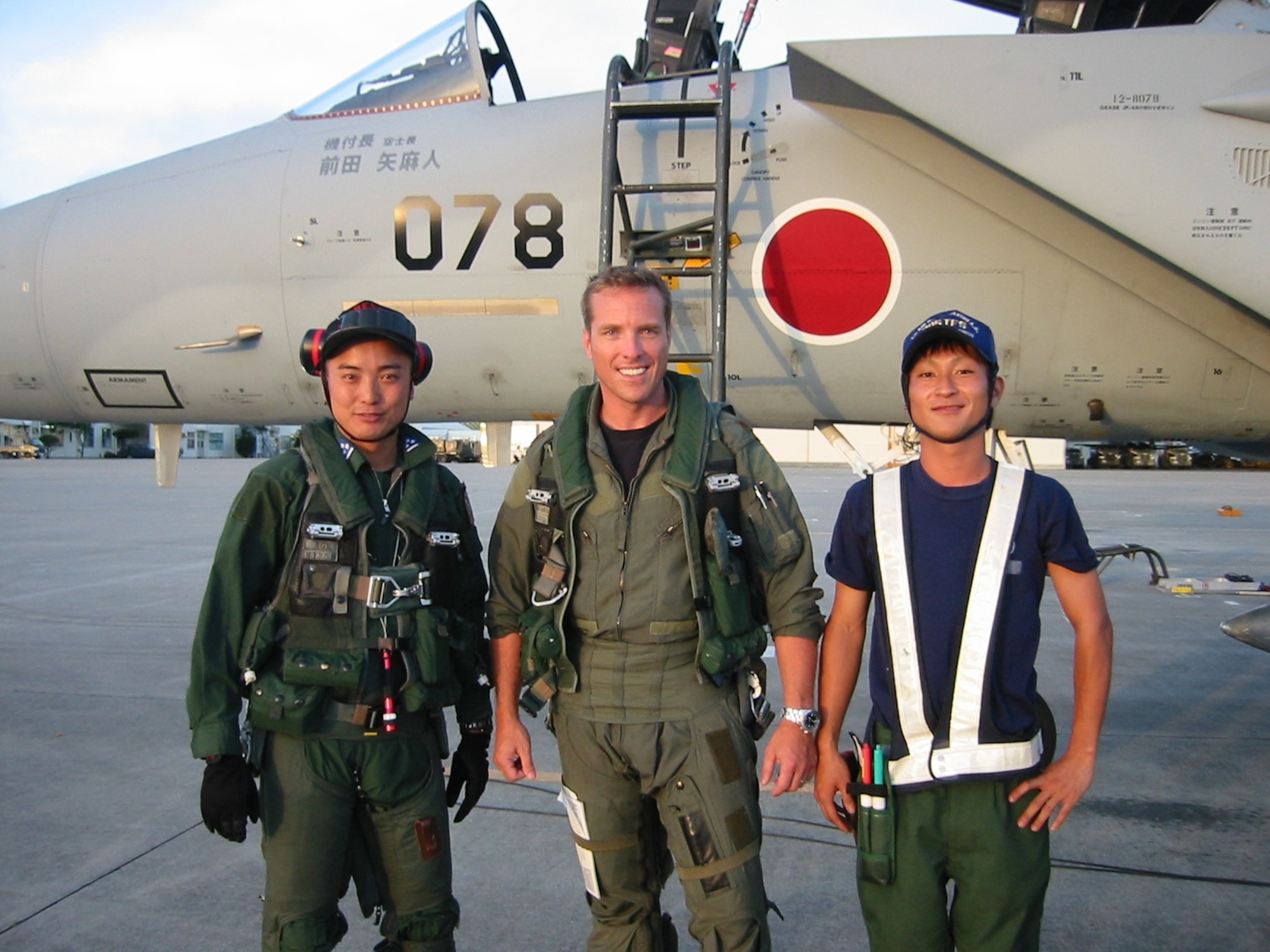 Captain Alaric Michaelis,  95th Fighter Squadron instructor pilot, stands near a Japanese F-15J aircraft with a Japan Air Self-Defense Force pilot and his crew chief. Two instructor pilots from the 95th FS particiapted in international training missions this month in Japan.  