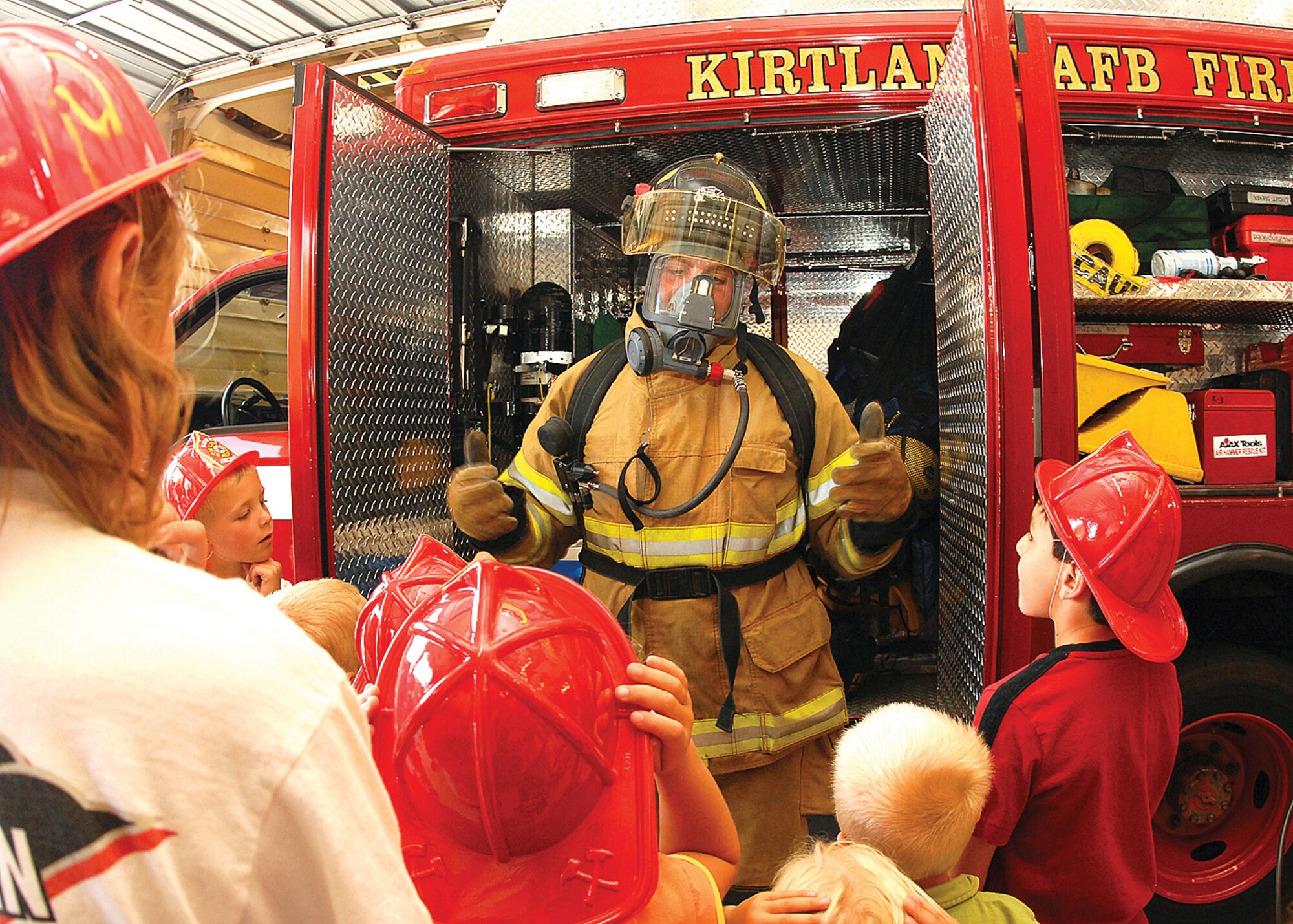 Firefighter Steve Rice dons his bunker gear to demonstrate the importance of the protective gear when firefighters have to respond to a fire. U.S. Air Force photo by Todd Berenger
