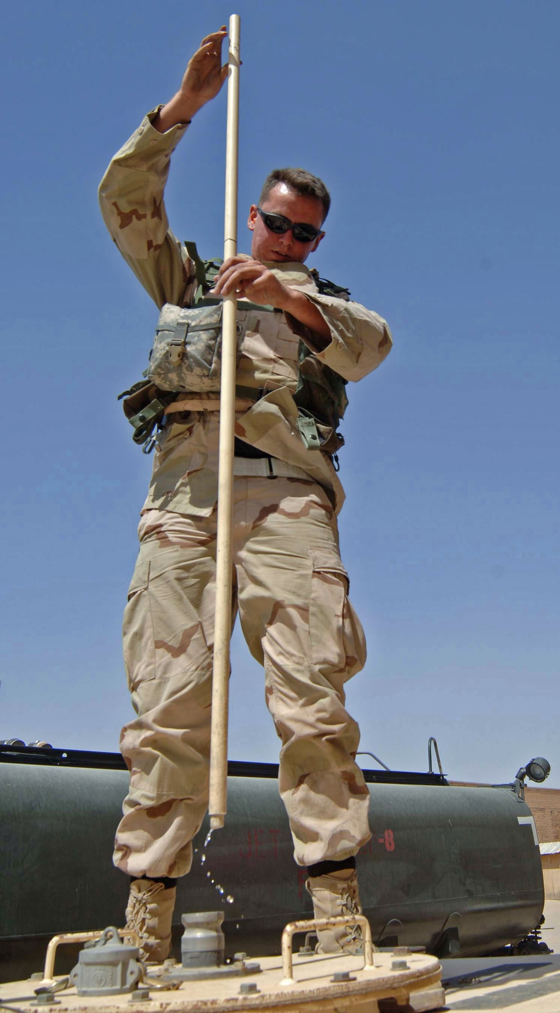 Senior Airman Chris Macfadden, a fuel distribution technician, checks the fuel level June 14 in a generator that supplies electrical power to the units at Baghdad International Airport, Iraq. Airman Macfadden is assigned to the 447th Expeditionary Logistics Readiness Squadron at Sather Air Base, Iraq. (U.S. Air Force photo/Tech. Sgt. Russell Wicke)