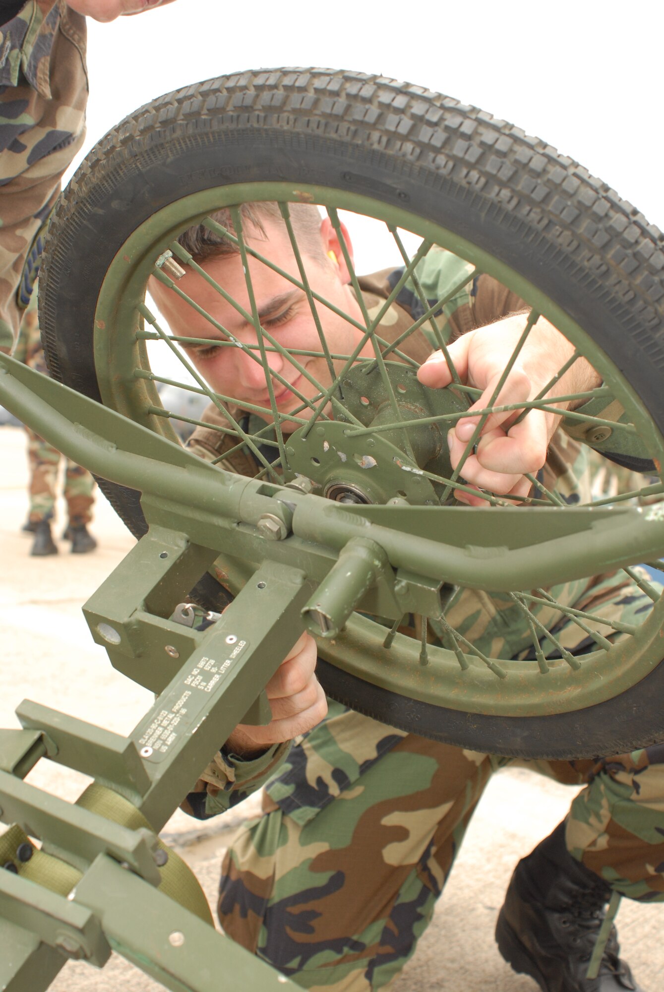 Staff Sgt. Paul Dobbs, 189th Medical Group Aerospace Medical Services Journeyman, constructs a wheeled litter carrier during a hurricane evacuation training exercise, at Little Rock Air Force Base, Ark., June 11, 2007. During the exercise, active duty and national guard airmen at LRAFB teamed up with local Veterans Affairs Emergency staff for a Major Accident Response Exercise to become better prepared for future hurricane or disaster evacuations. (U.S. Air Force photo by Airman First Class Jim Araos)