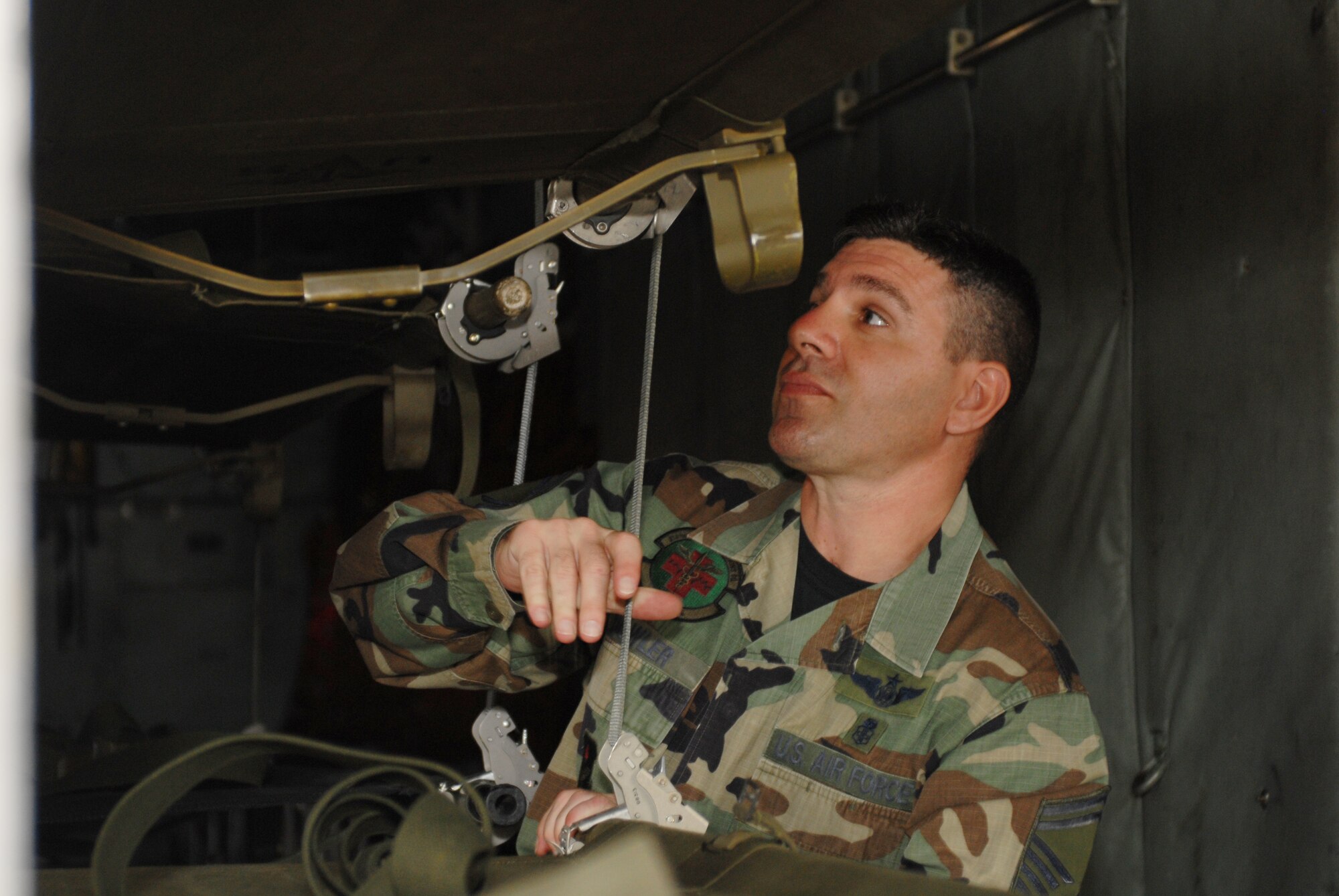 Senior Master Sgt. Marc Dowler, 314th Medical Group Superintendent of Primary Care Flight, secures litters in a C-130 during a hurricane evacuation training exercise, at Little Rock Air Force Base, Ark., June 11, 2007. During the exercise, active duty and national guard airmen at LRAFB teamed up with local Veterans Affairs Emergency staff for a Major Accident Response Exercise to become better prepared for future hurricane or disaster evacuations. (U.S. Air Force photo by Airman First Class Jim Araos)