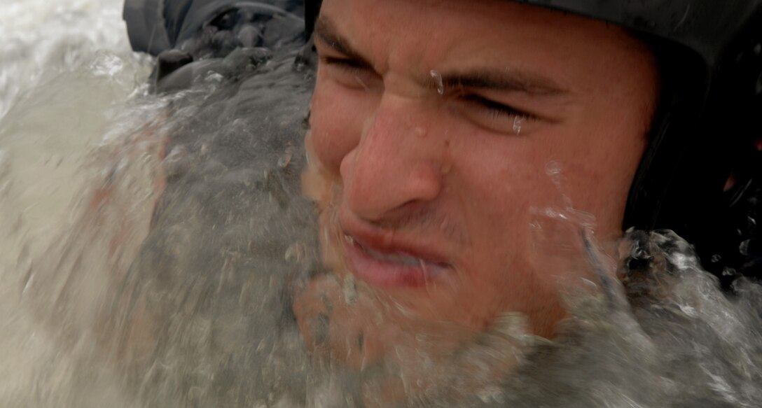 LANGLEY AIR FORCE BASE, Va. -- Domingo Astiasaran, Air Force Academy cadet, fights the saltwater while trying to stay afloat in a parachute disentanglement exercise during survival, evasion, resistance and escape water survival training here June 20. During the summer, the 1st Operations Support Squadron holds SERE training sessions twice a month for cadets entering pilot training.  (U.S. Air Force photo/Senior Airman Tabitha Kuykendall)
