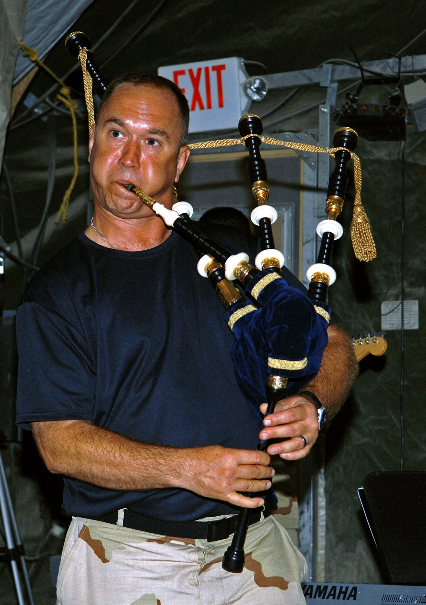 Master Sgt. Scott Gunn squeezes out a song on his bagpipes during an impromptu performance June 19 at Bagram Air Base, Afghanistan. Sergeant Gunn is the U.S. Central Command Air Forces Band tenor sax, bagpipe and guitar player. The band played for Airmen assigned to the 455th Air Expeditionary Wing at Bagram AB. (U.S. Air Force photo/Staff Sgt. Craig Seals) 
