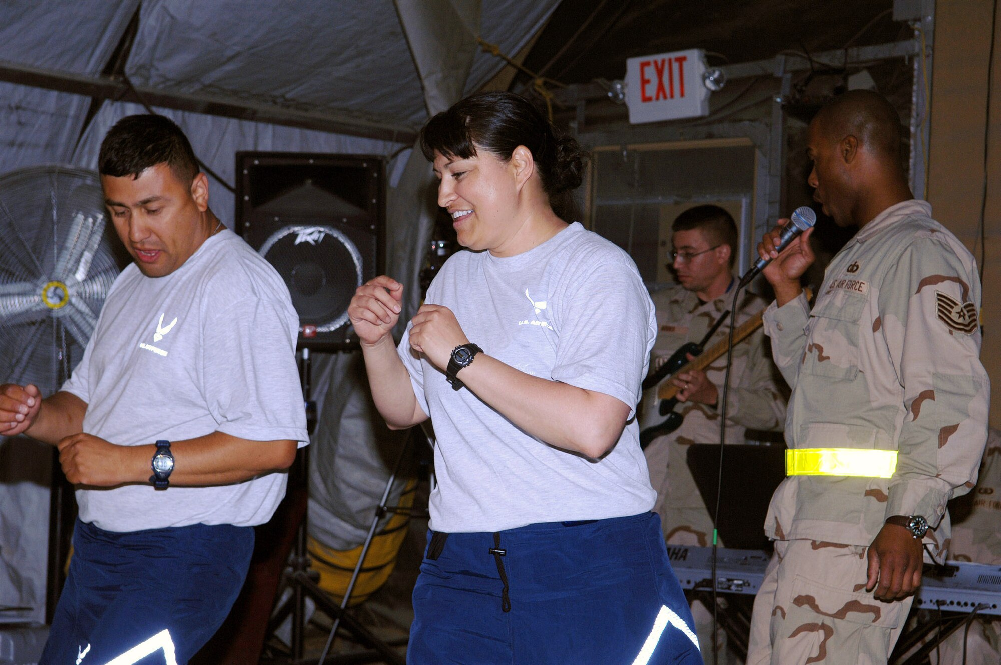 Capt. Nicole Chavez (middle) dances to the beat of the U.S. Central Command Air Forces Band during an impromptu performance June 19 at Bagram Air Base, Afghanistan. Captain Chavez is the 455th Expeditionary Mission Support Group executive officer. (U.S. Air Force photo/Staff Sgt. Craig Seals)