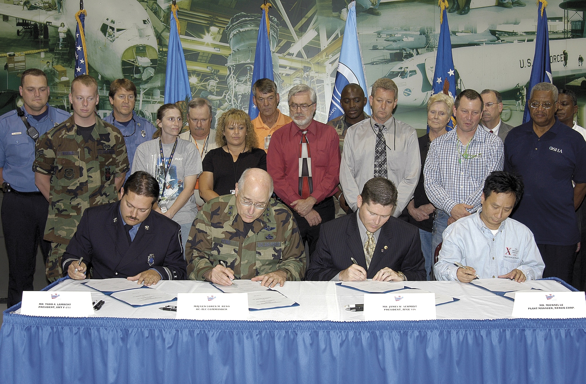 Todd Lambert, International Association of Firefighters F-211 president; Maj. Gen. Loren M. Reno, Oklahoma City Air Logistics Center commander; James Schmidt, American Federation of Government Employees 916 president; and Michael Le, Xerox Corporation plant manager, from left, sign the Occupational Safety and Health Administration’s Voluntary Protection Program agreement June 18 at Tinker.  VPP is a higher commitment to worker safety and a program Xerox has embraced for months. Xerox will mentor Tinker as the base implements the process. (Air Force photo by Margo Wright)
