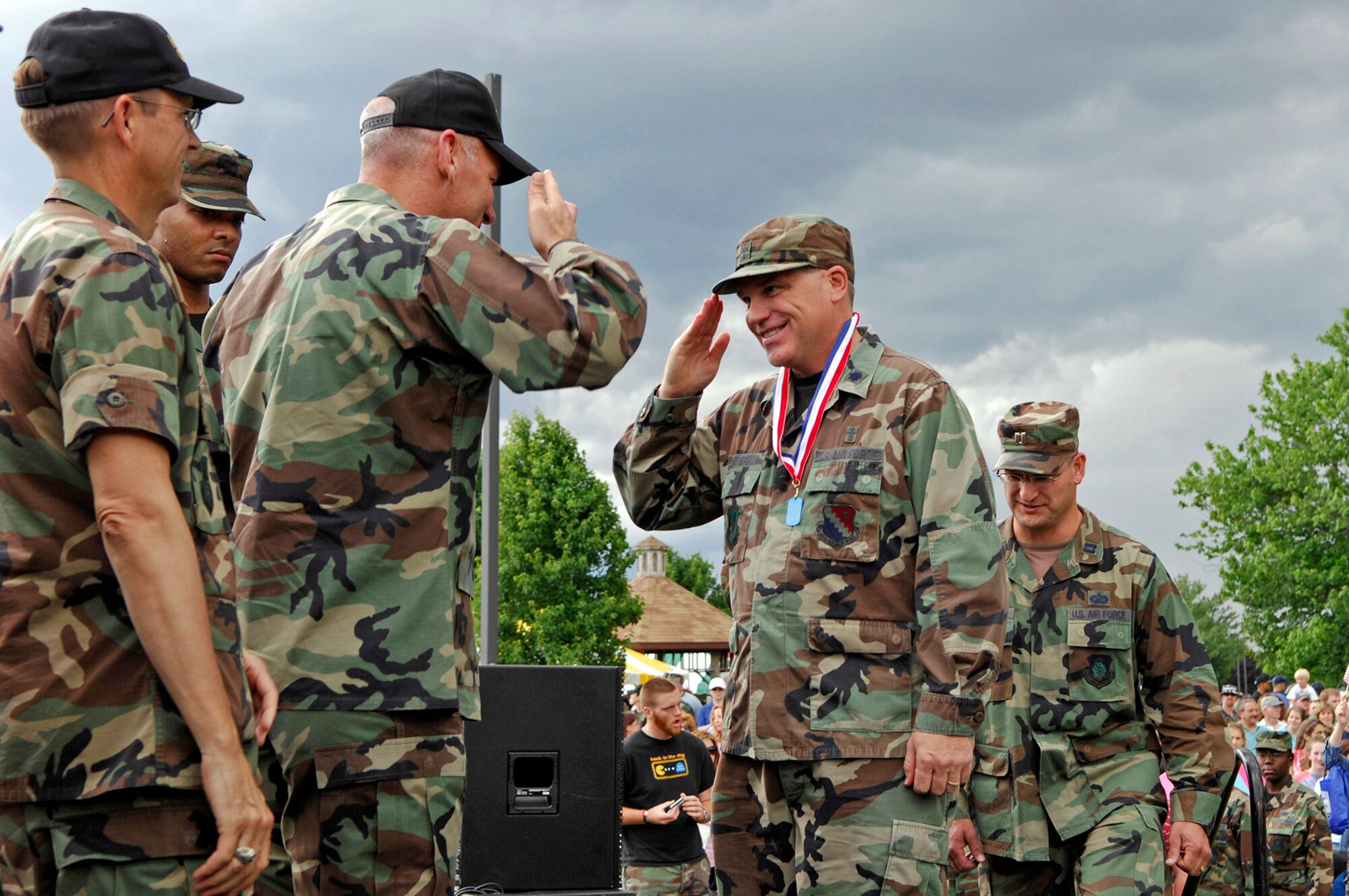 Chaplain (Lt. Col.) Dennis Kitterman receives a medallion from Col. Tom Schluckebier during Hanscom's Heroes' Homecoming June 22 at Hanscom Air Force Base, Mass. During the event, more than 60 servicemembers who deployed within the last six months were formally welcomed home and recognized for their service. Chaplain Kitterman is the wing chaplain for the 66th Air Base Wing and Colonel Schluckebier is the 66th ABW commander. (U.S. Air Force photo/Mark Wyatt)
