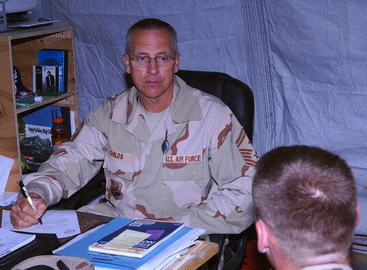 Senior Master Sgt. Ross Childs, 455th Expeditionary Mission Support Group first sergeant, mentors a young Airman in his office at Bagram Airfield, Afghanistan. Part of Sgt. Child's duties as a first sergeant include mentoring and assisting Airmen with any problems they might have. Sgt. Childs is deployed from the Utah Air National Guard's 67th Aerial Port Squadron. (photo by Staff Sgt. Craig Seals)