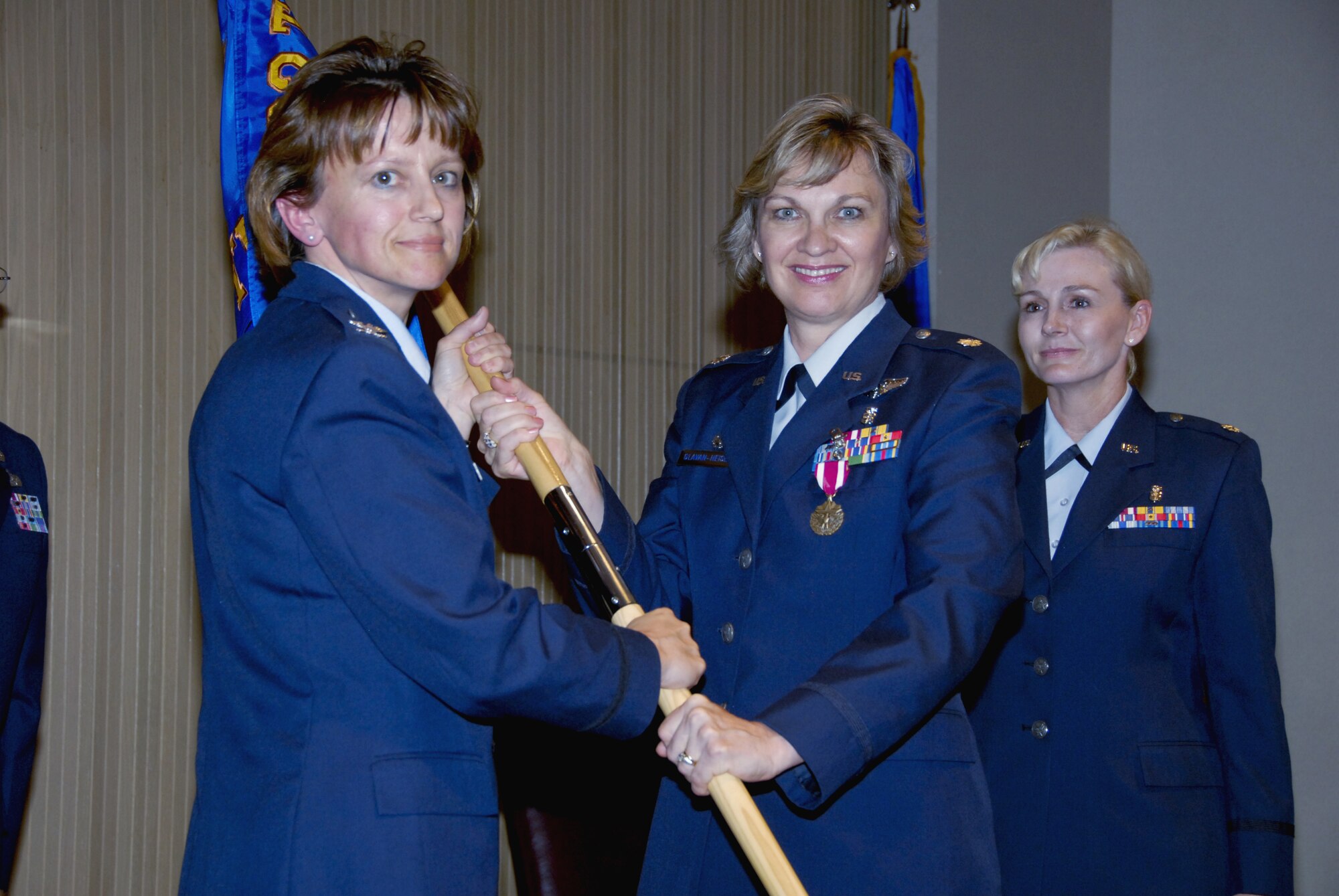 Lt. Col. Katrina Glavan-Heise, outgoing 383rd Training Squadron Commander, passes the guidon to 882nd Training Group Commander Col. Nancy Dezell during the 383rd Training Squadron change-of-command ceremony. (U.S. Air Force photo/Sandy Wassenmiller)