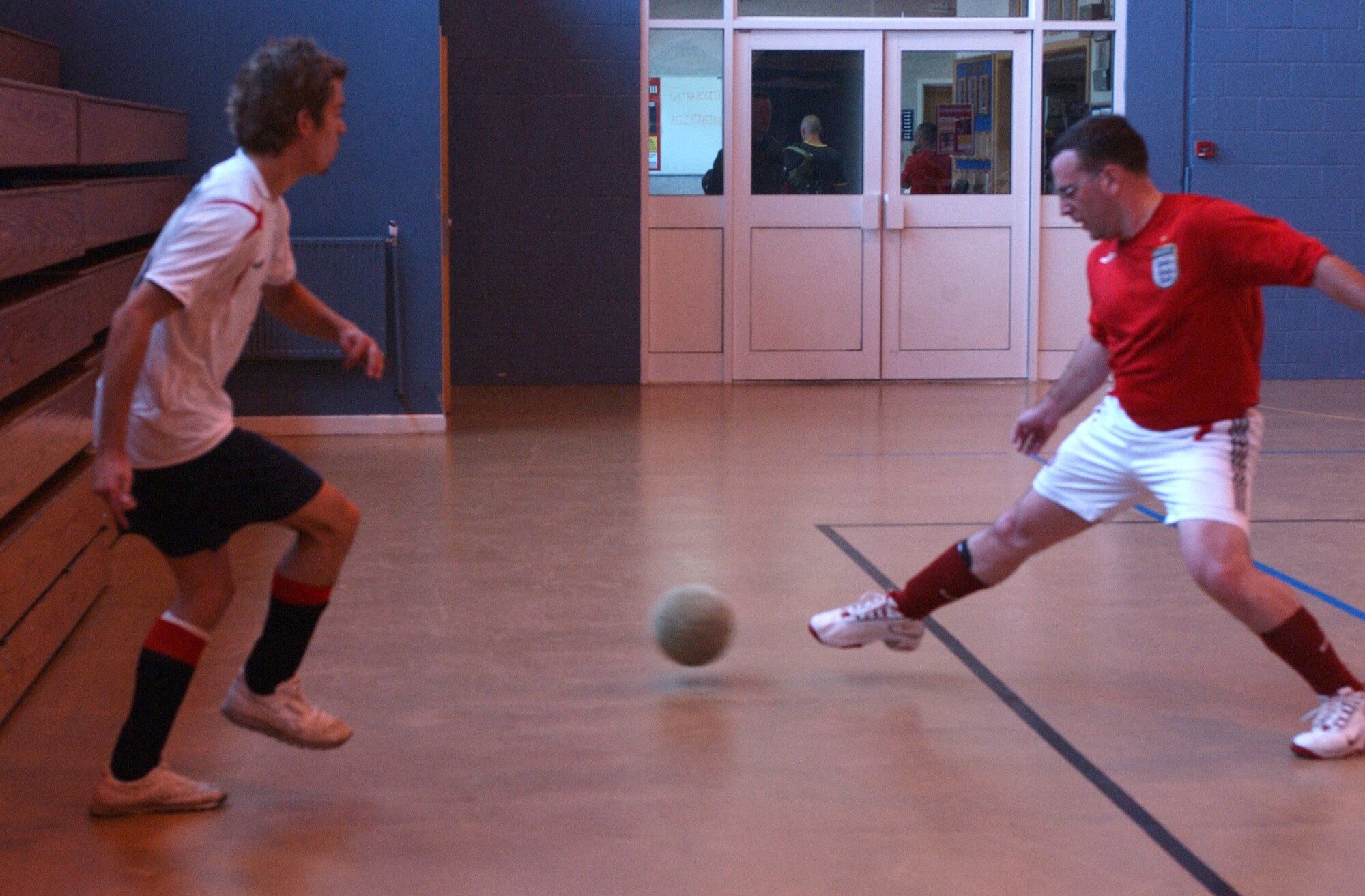 Geoff Gough, 100th CES, slides the ball past Nathan Mcleod, 727th AMS. (Air Force photo Airman Brad Smith)