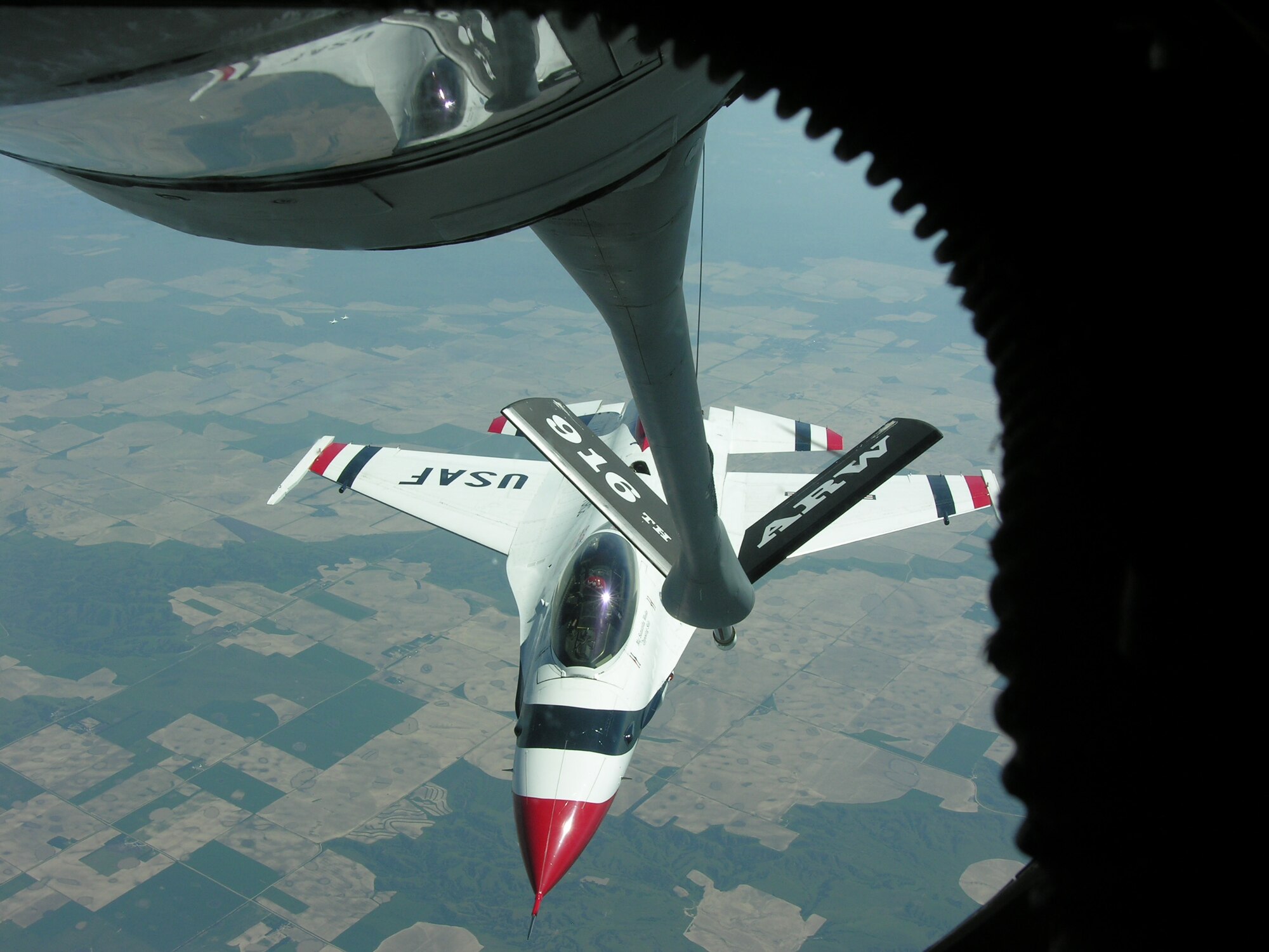 SEYMOUR JOHNSON AIR FORCE BASE, N.C. -- On a beautiful day in early June a KC-135 Stratotanker from the 916th Air Refueling Wing, Air Force Reserve, refuels a plane from the Air Force's aerial demonstration team, the Thunderbirds.  The F-16 Fighting Falcon took on fuel over the Chicago area after finishing an airshow in Davenport, Iowa.
